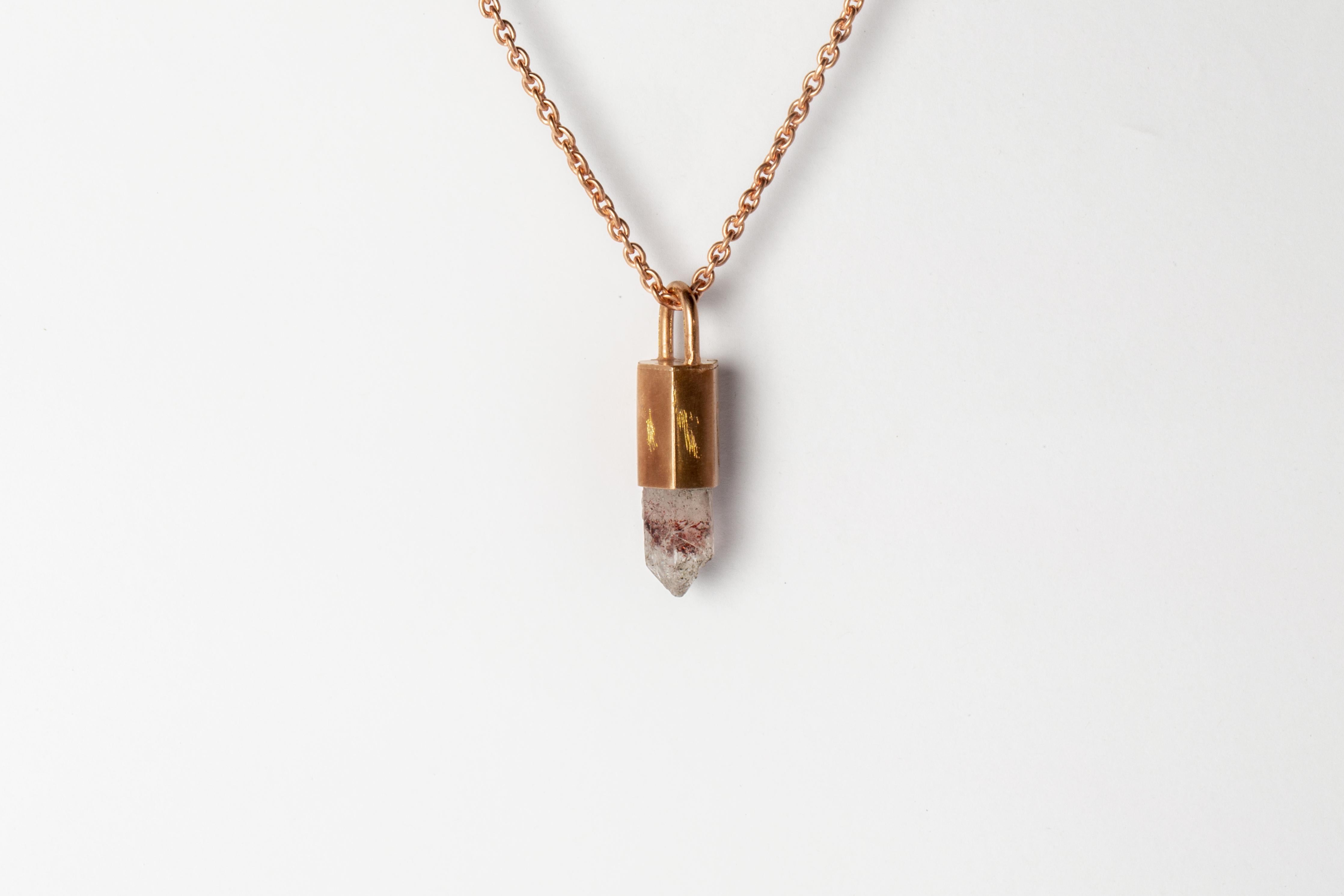 Pendant necklace in brass, sterling silver, and a rough of hematite quartz. Brass and sterling silver substrates are electroplated with 18k rose gold and then dipped into acid to create the subtly destroyed surface.
The Talisman series is an