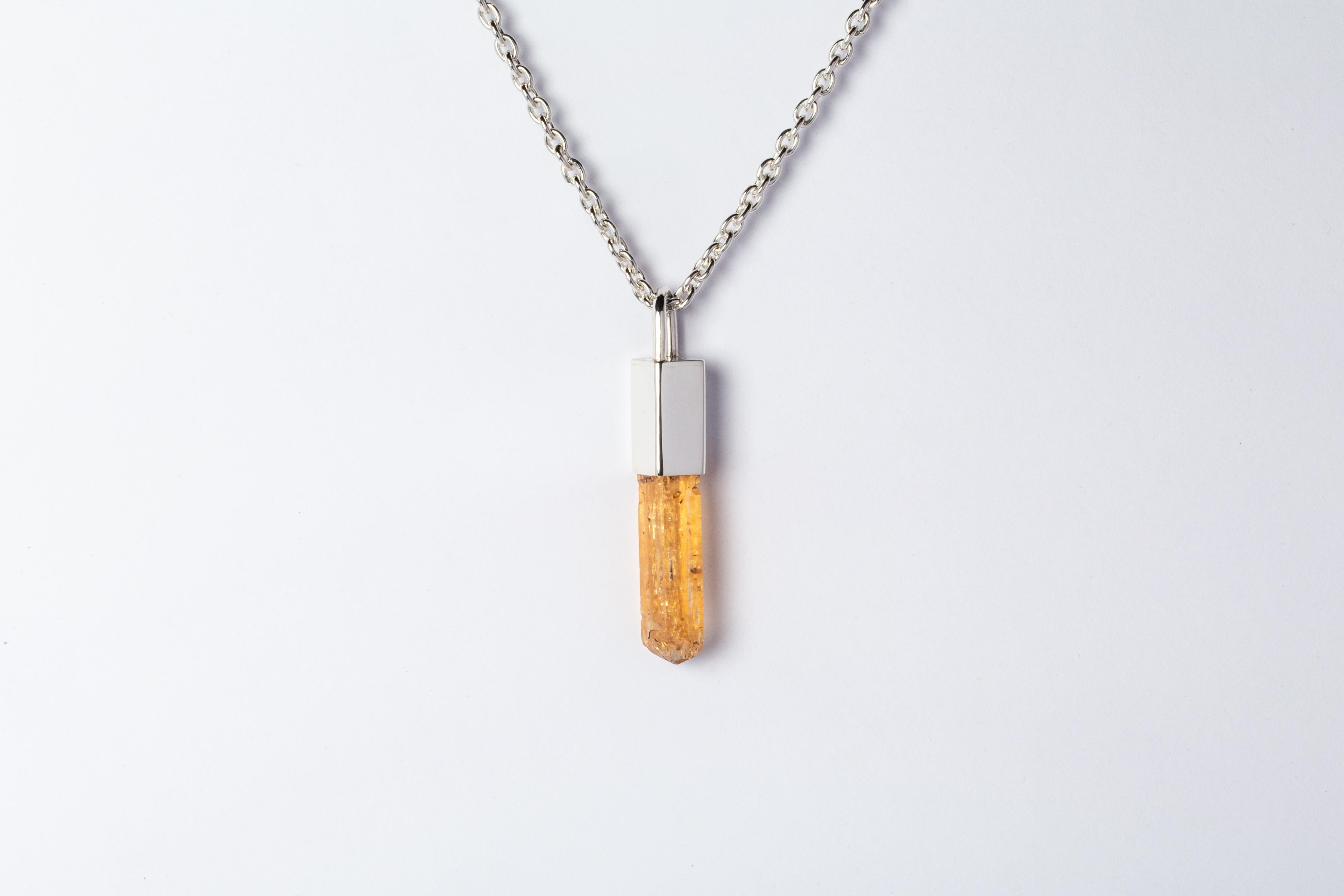 Necklace in polished sterling silver and a rough imperial topaz. The Talisman series is an exploration into the power of natural crystals. The crystals used in these pieces are discovered through adventure and are hand selected. Each piece is unique