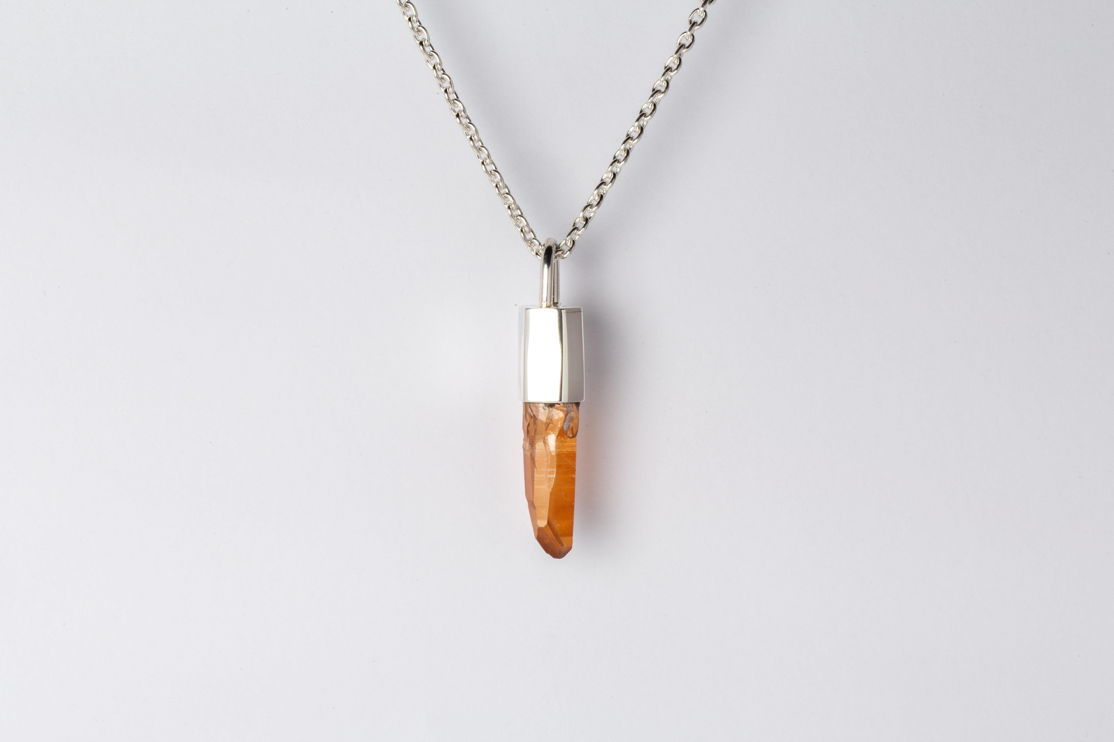 Pendant necklace in polished sterling silver and a rough of iron quartz. It comes on 74 cm sterling silver chain.
The Talisman series is an exploration into the power of natural crystals. The crystals used in these pieces are discovered through