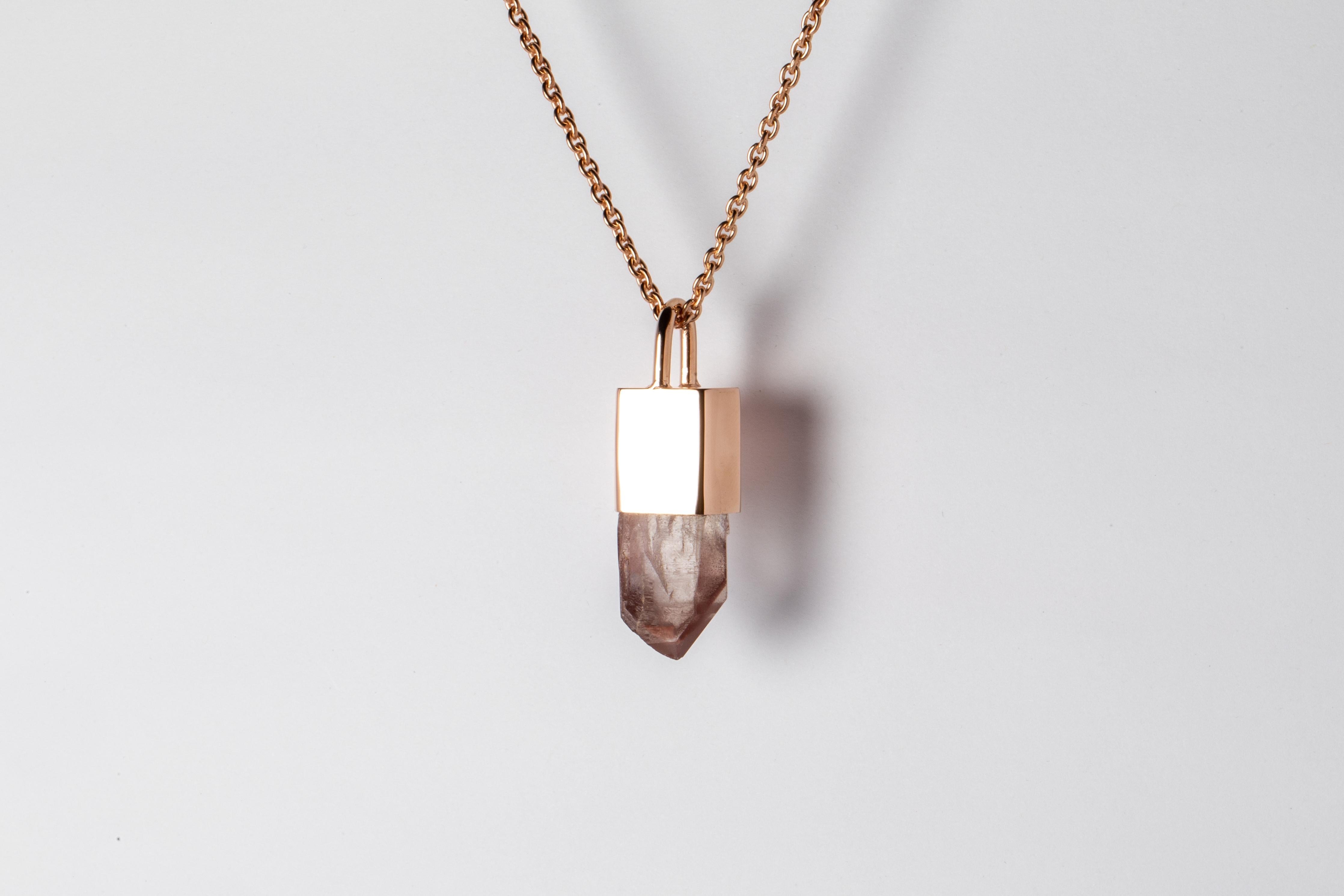 Necklace made in brass, sterling silver, and a rough of iron quartz. Brass and sterling silver are substrate, polished, and electroplated with 18k rose gold. It comes on a 75 cm sterling silver. The Talisman series is an exploration into the power