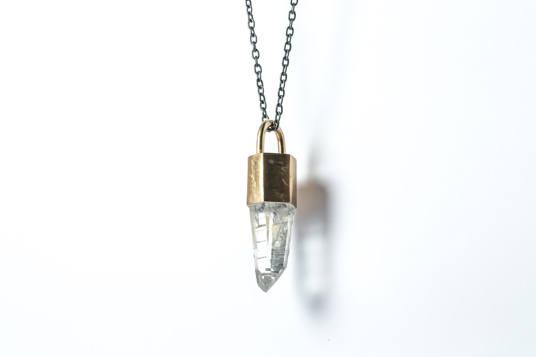 Talisman necklace in electroplated brass with 18k gold surface, oxidized sterling silver, and a rough of lemurian quartz. The Talisman series is an exploration into the power of natural crystals. Tools for Magic. The crystals used in these pieces