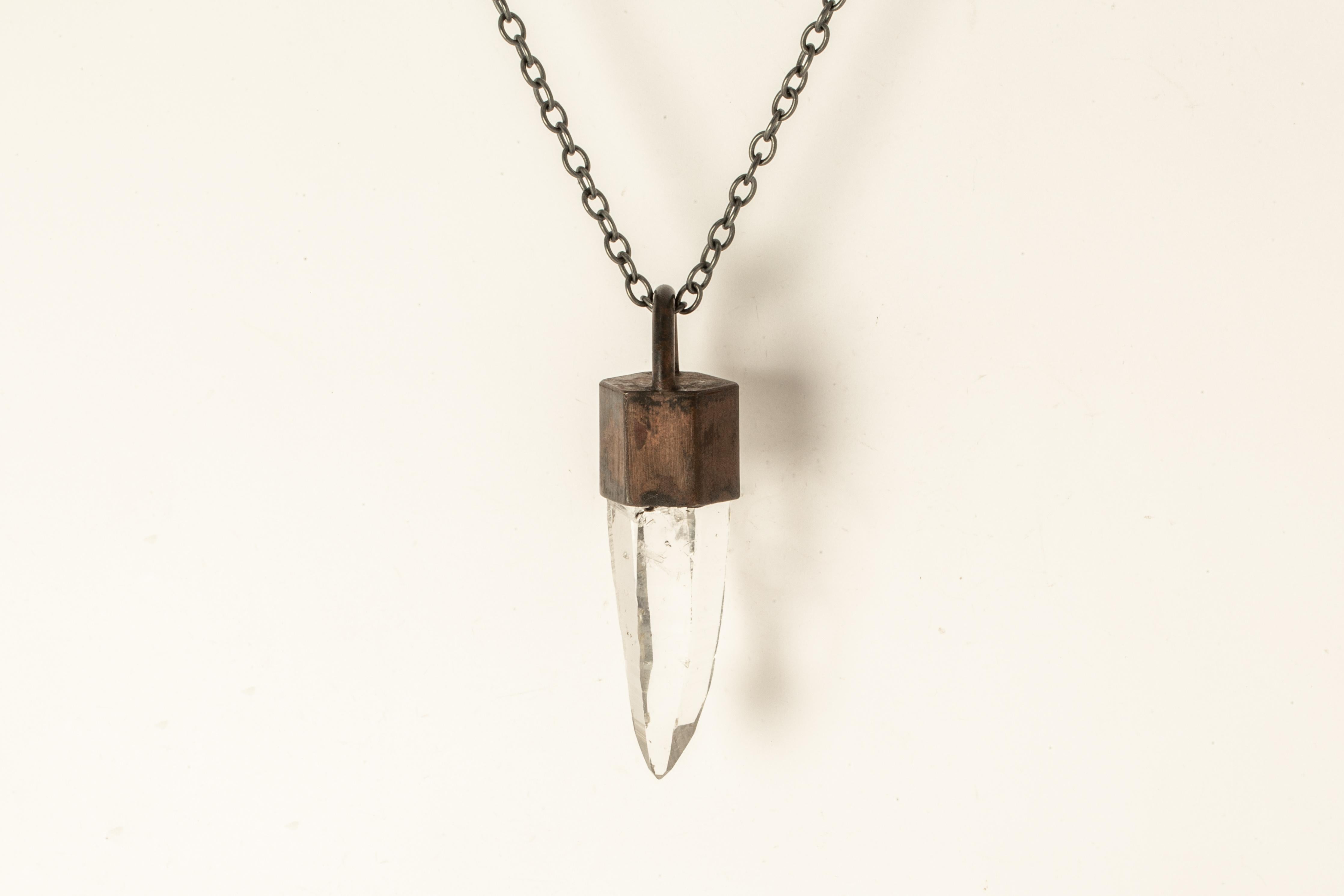 Necklace in dirty brass, oxidized sterling silver, and a rough of lemurian quartz. The Talisman series is an exploration into the power of natural crystals. Tools for Magic. The crystals used in these pieces are discovered through adventure and are