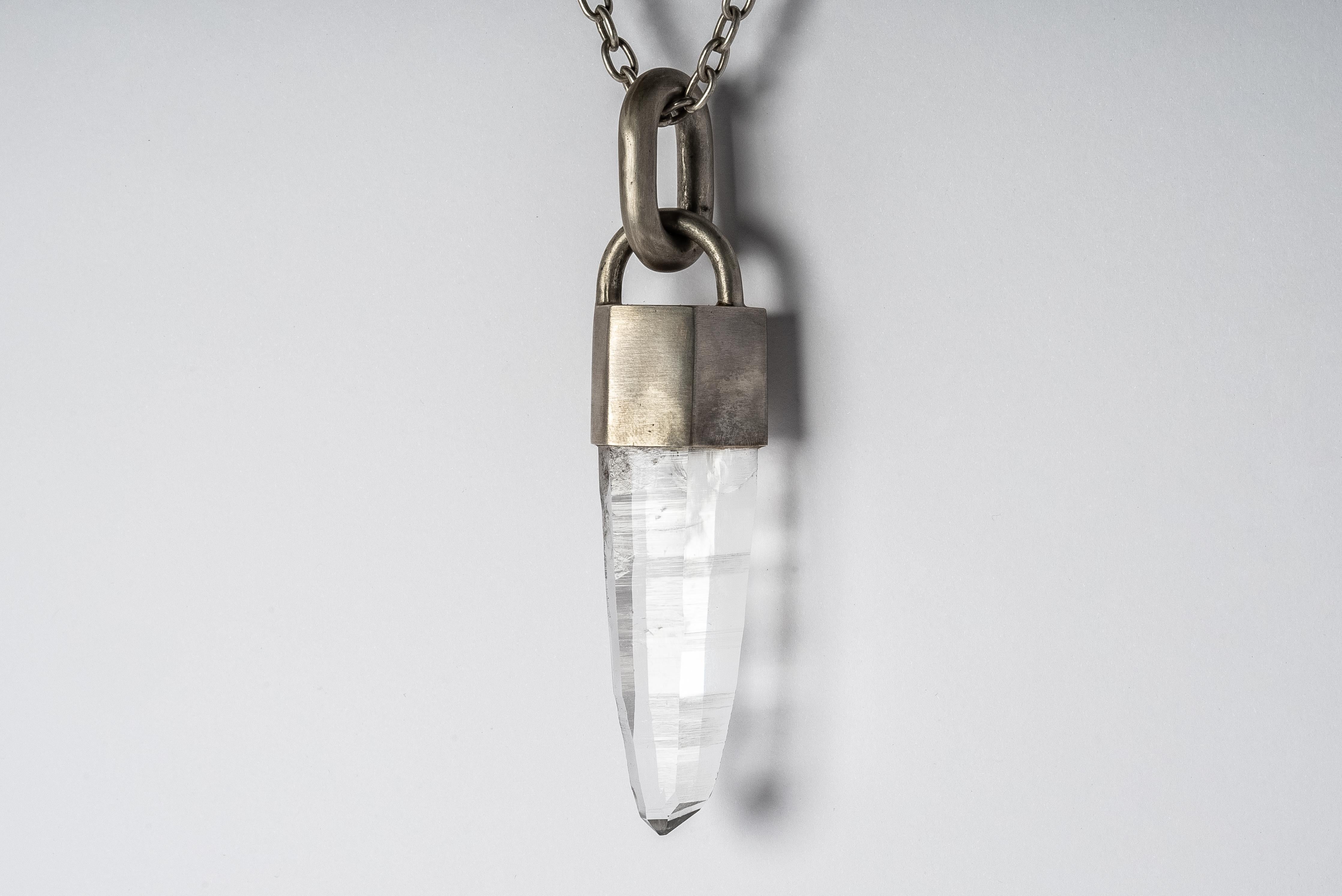 Necklace in acid treated sterling silver and a slab of rough lemurian quartz. The Talisman series is an exploration into the power of natural crystals. Tools for Magic. The crystals used in these pieces are discovered through adventure and are hand