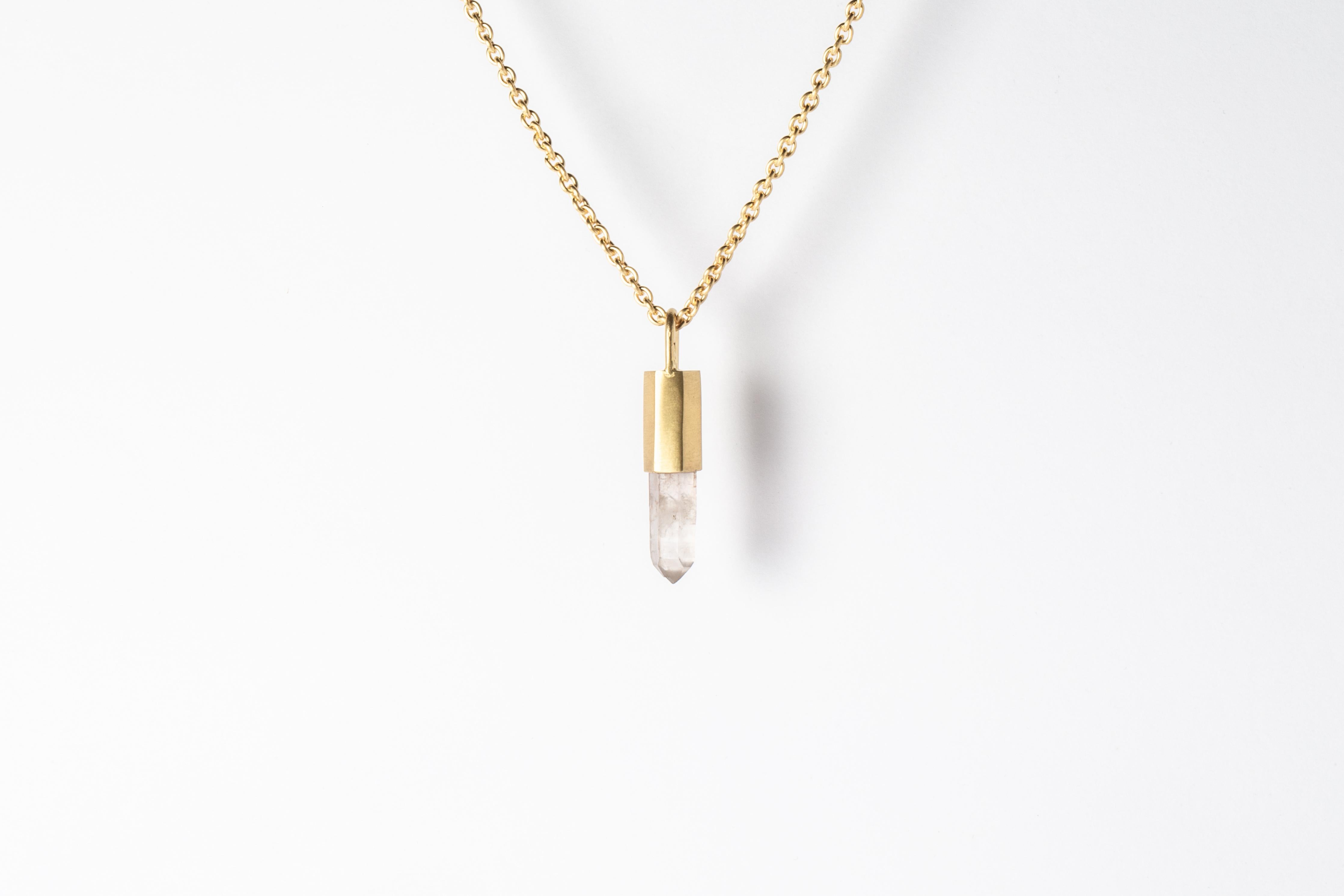 Necklace in brass, sterling silver, and a rough of misc quartz. Brass and sterling silver are  electroplated with 18k gold and lightly dipped in acid. It comes on 74 cm sterling silver chain.
The Talisman series is an exploration into the power of
