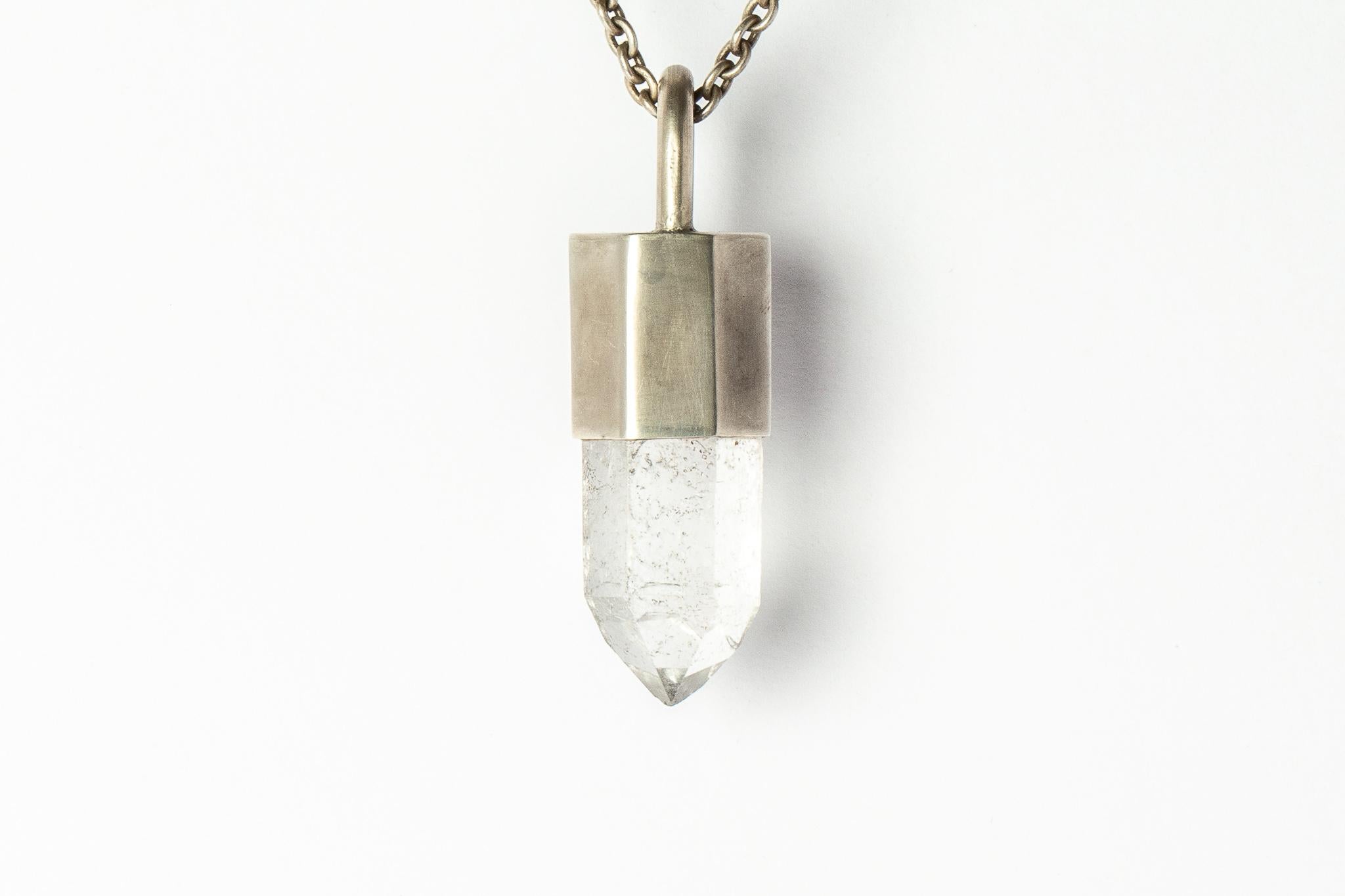 Pendant necklace in acid treated sterling silver and a rough of misc quartz. It comes on 74 cm sterling silver chain.
The Talisman series is an exploration into the power of natural crystals. The crystals used in these pieces are discovered through