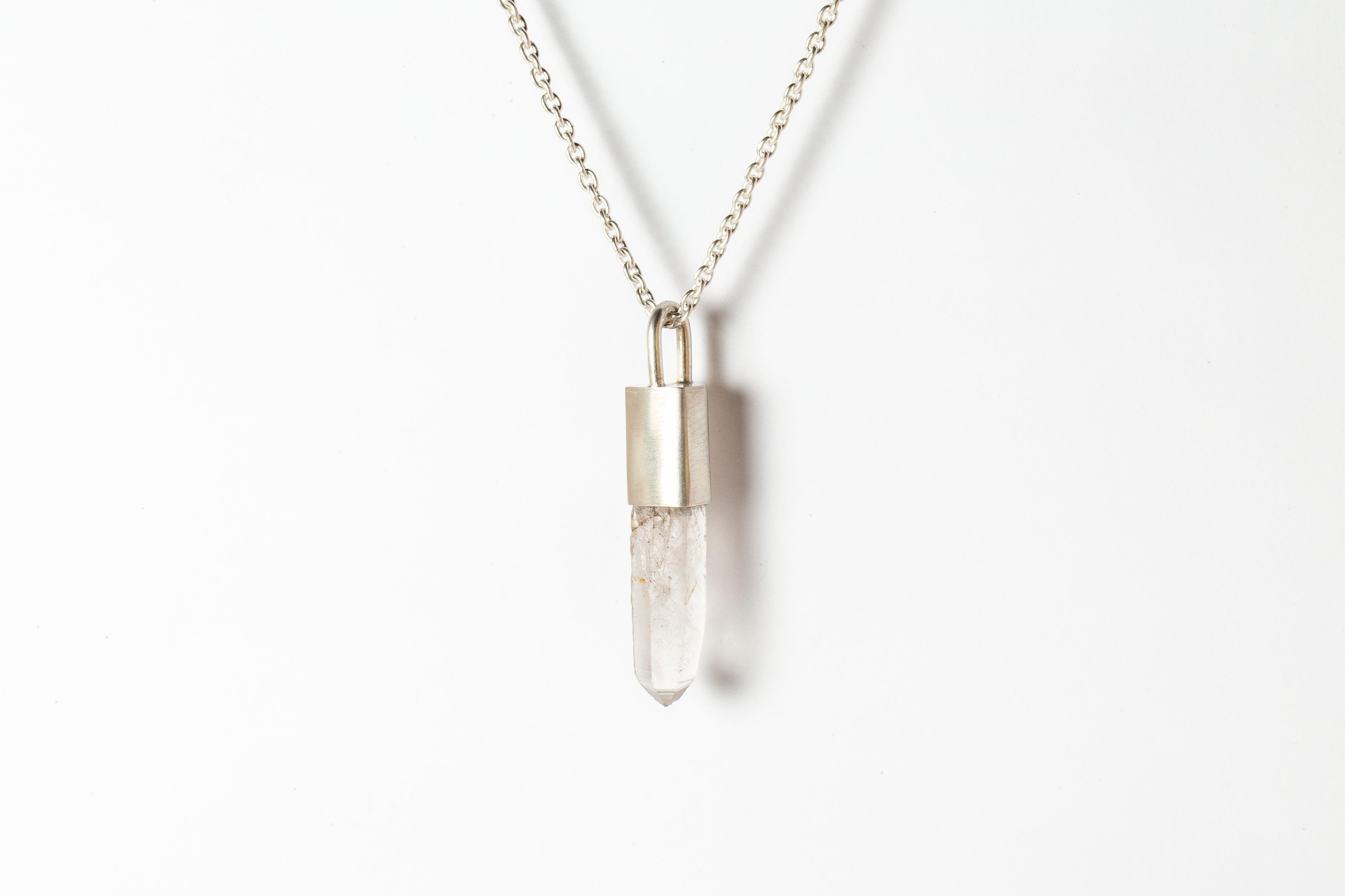 Pendant necklace in matte sterling silver and a rough of Misc Quartz. It comes on 74 cm sterling silver chain.
The Talisman series is an exploration into the power of natural crystals. The crystals used in these pieces are discovered through