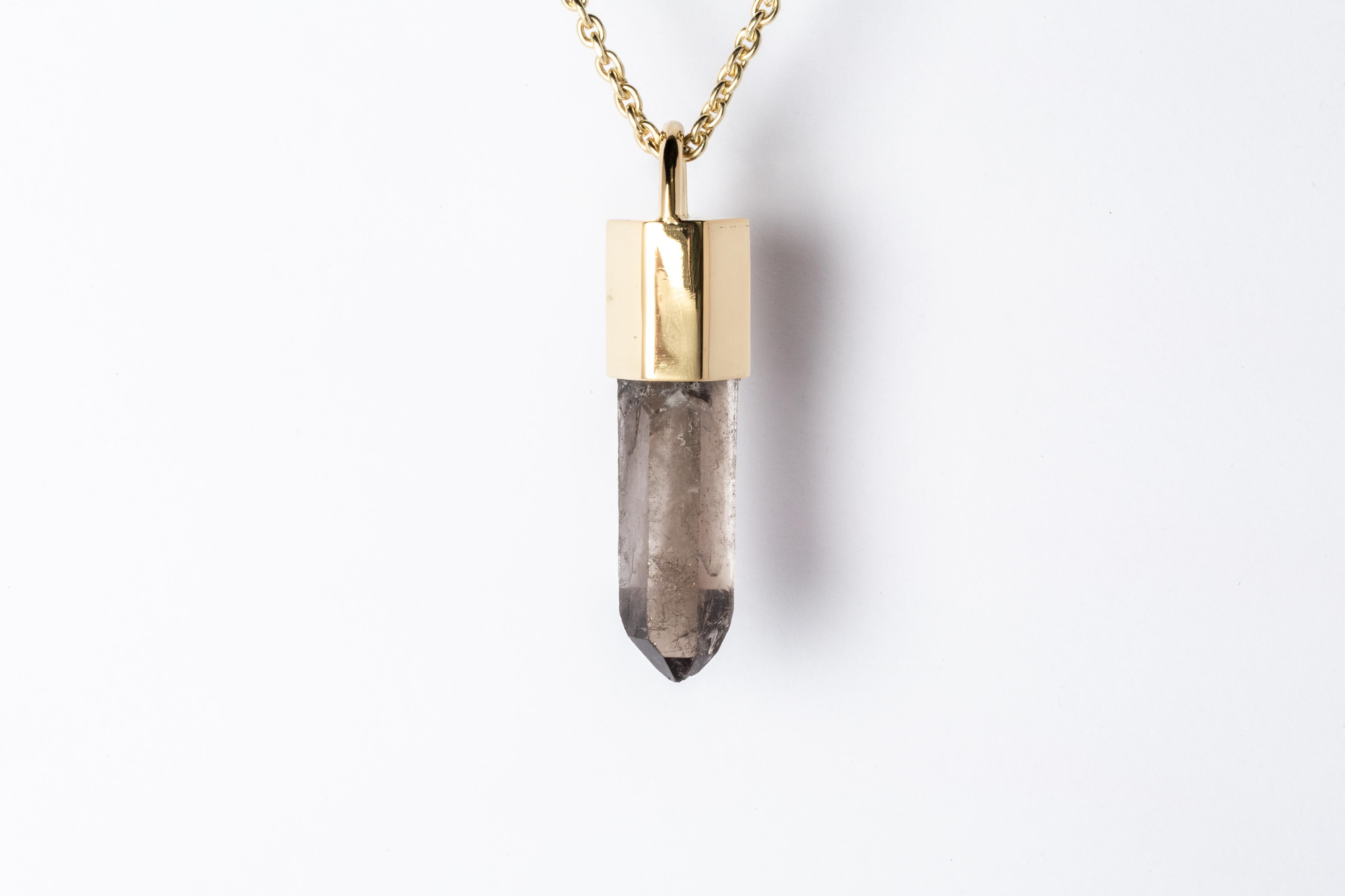 Pendant necklace made in brass, sterling silver, and a rough of Smoky Quartz. Brass and sterling silver are substrate, polished, and electroplated with 18k gold. It comes on 74 cm sterling silver chain.

The Talisman series is an exploration into
