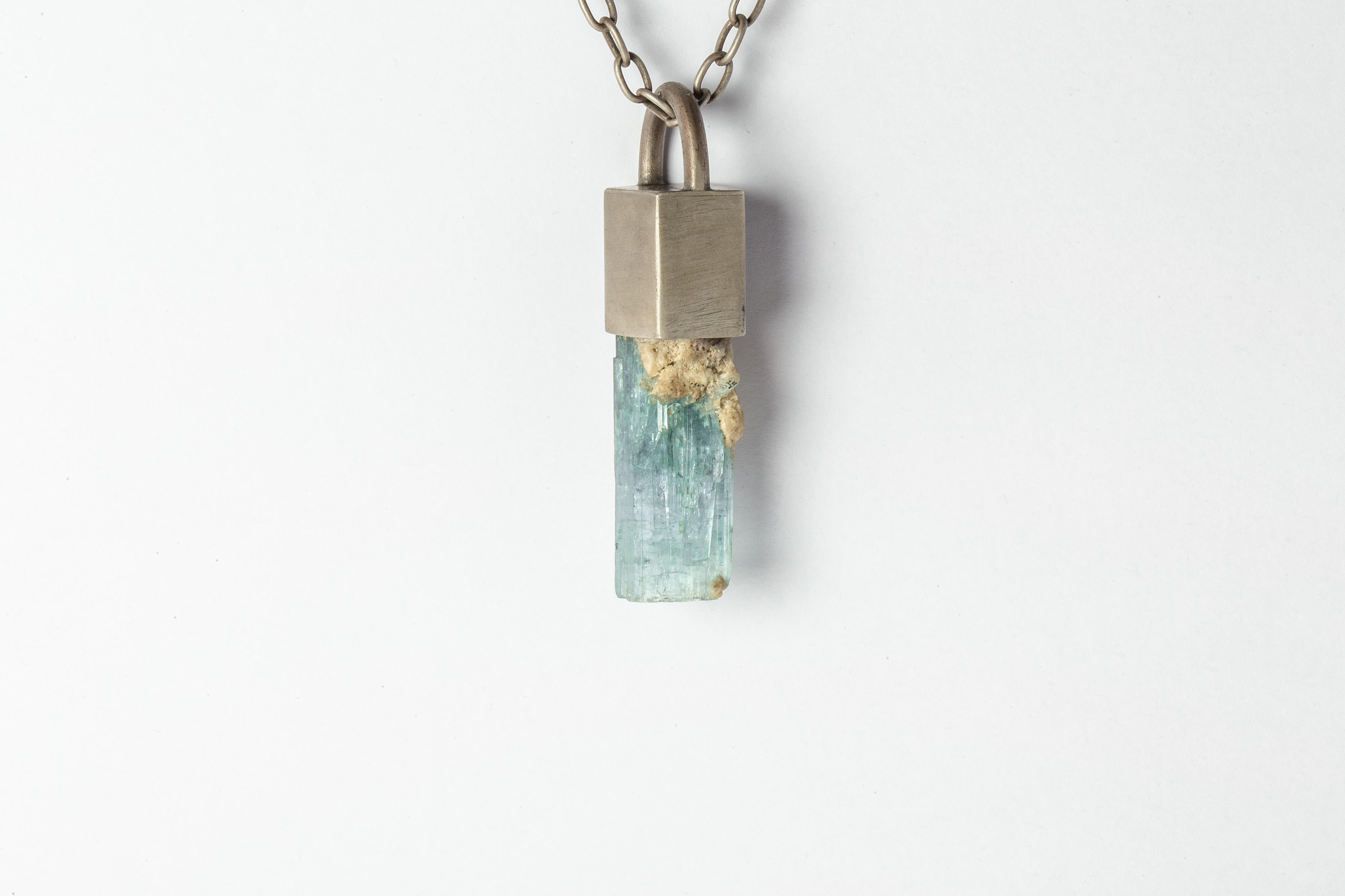 Necklace in sterling silver and rough of aquamarine. The Talisman series is an exploration into the power of natural crystals. Each piece is unique and special. The title Specimen signifies a particular class of mineral that is both rare and