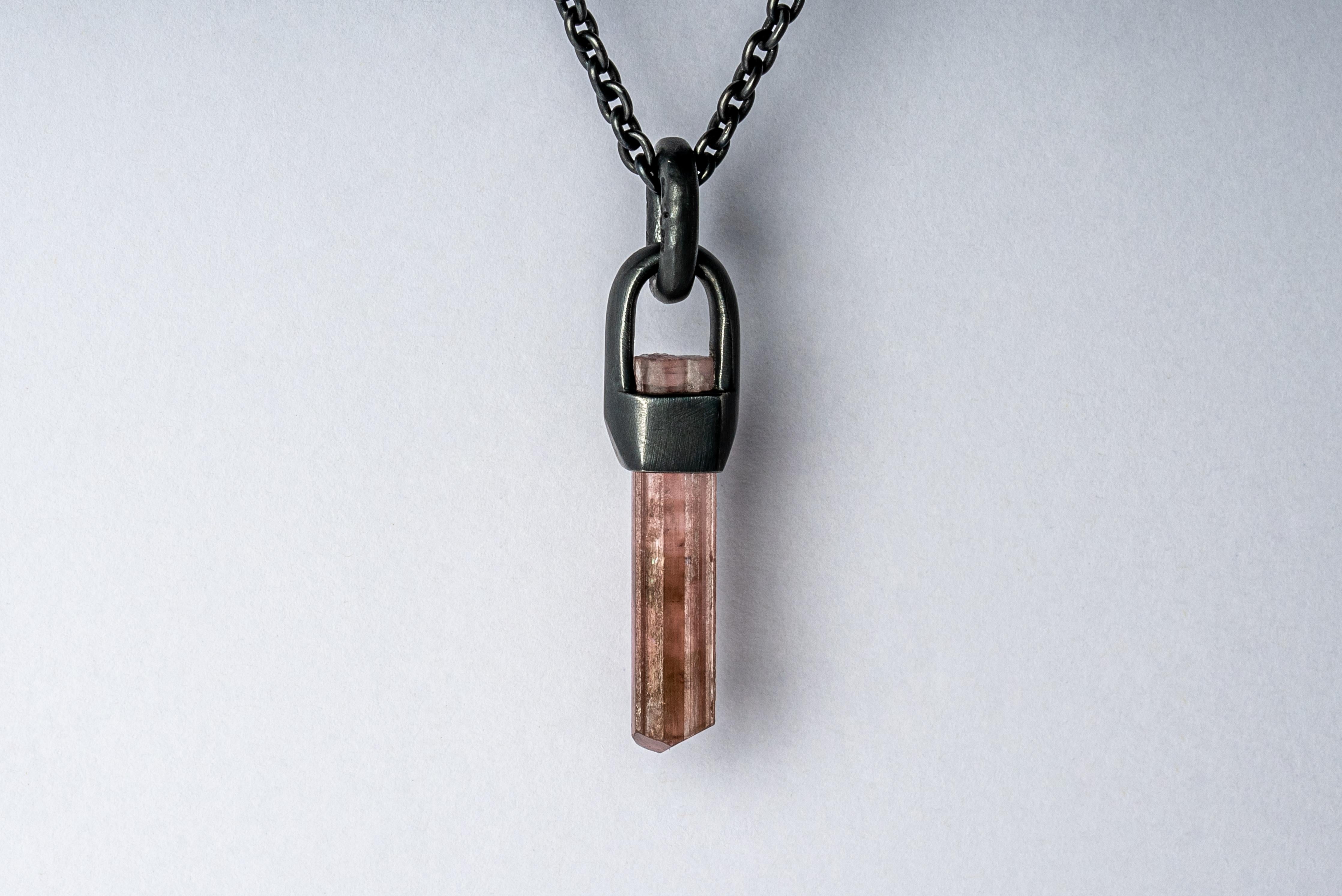 Necklace in oxidized sterling silver and a rough of rubellite, a pink-read tourmaline color. The Talisman series is an exploration into the power of natural crystals. Tools for Magic. The crystals used in these pieces are discovered through