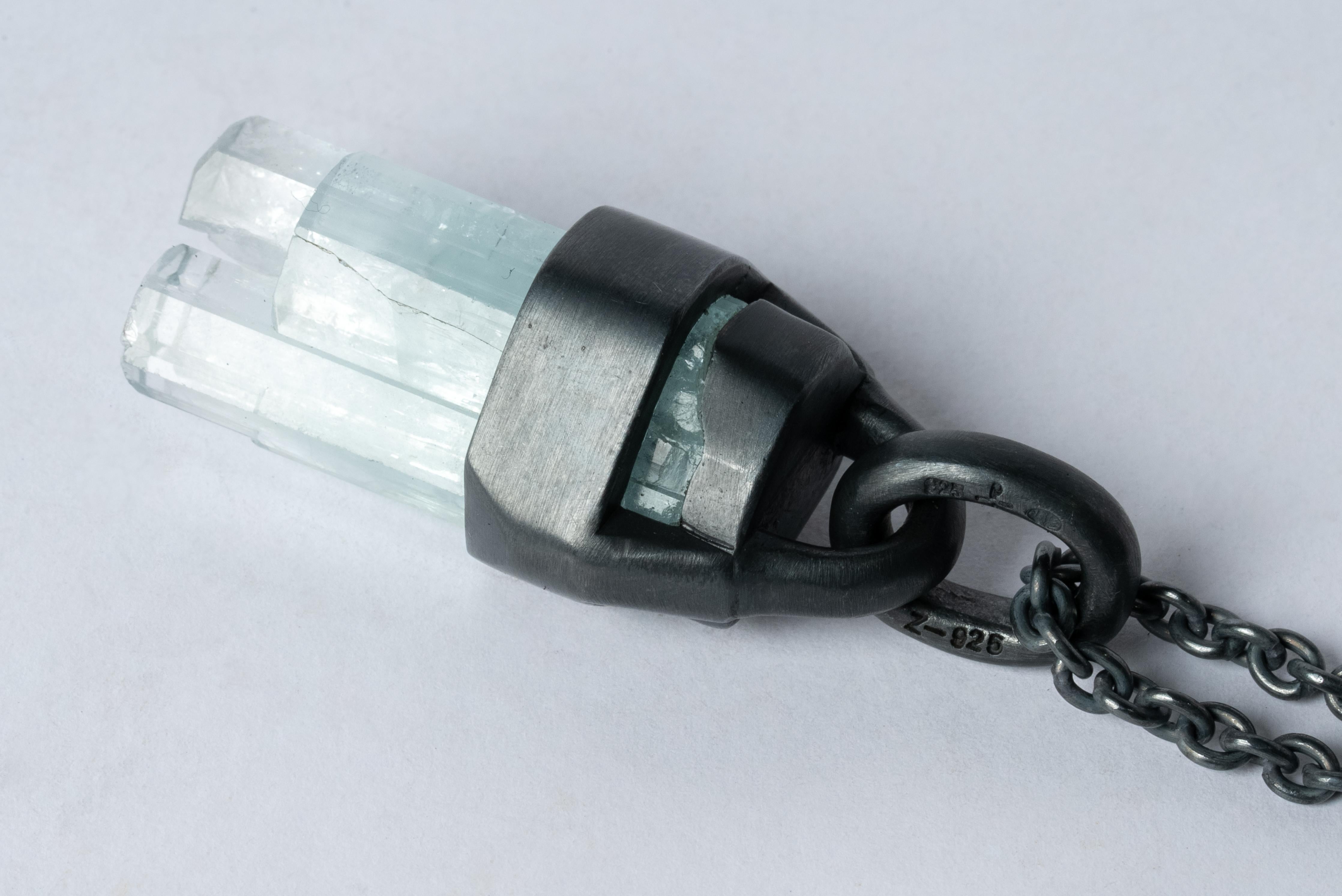 Talisman necklace in black sterling and a rough aquamarine. Black Sterling is a surface oxidation of sterling silver. This finish may fade over time, which can be considered an enhancement. The Talisman series is an exploration into the power of