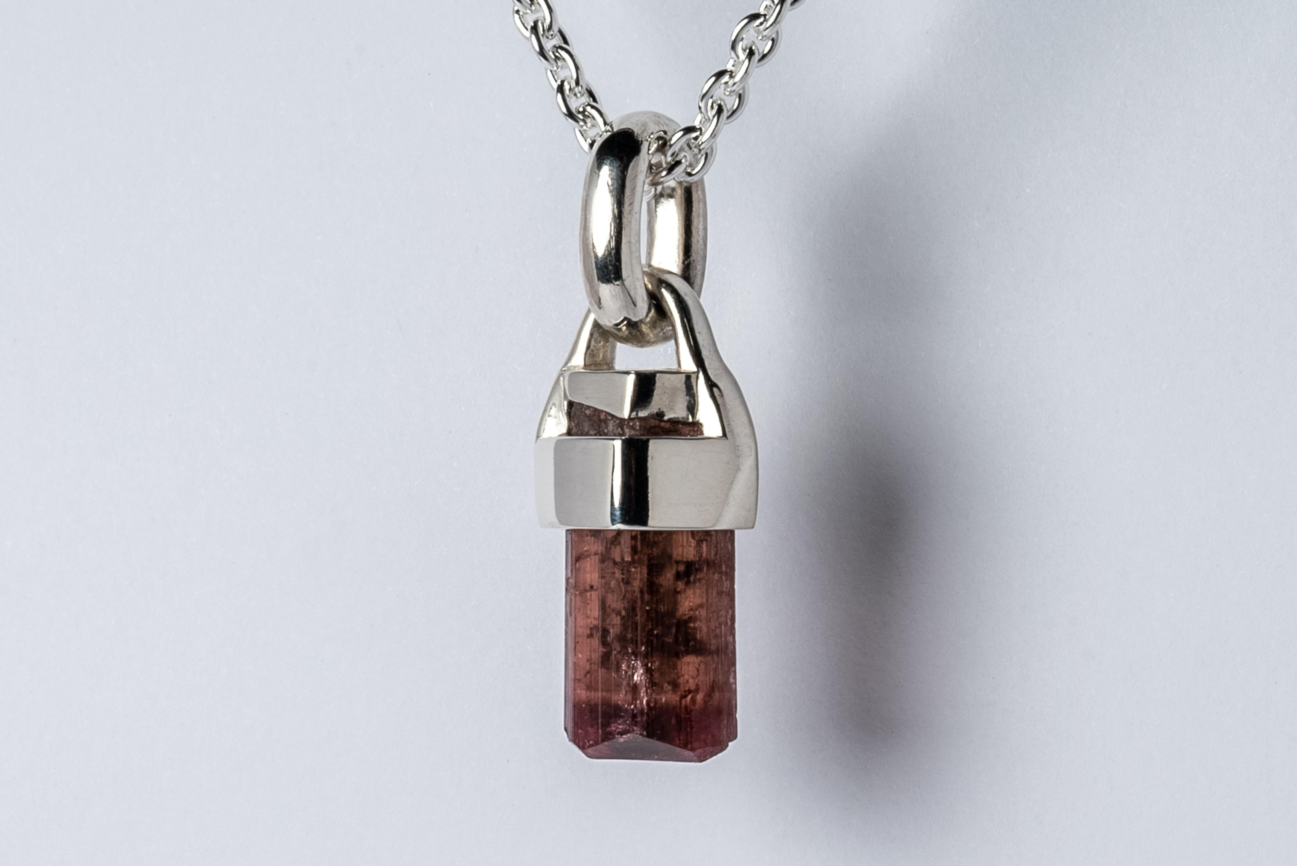Necklace in polished sterling silver and rough of rubellite, a pink-red tourmaline. The Talisman series is an exploration into the power of natural crystals. The crystals used in these pieces are discovered through adventure and are hand selected.