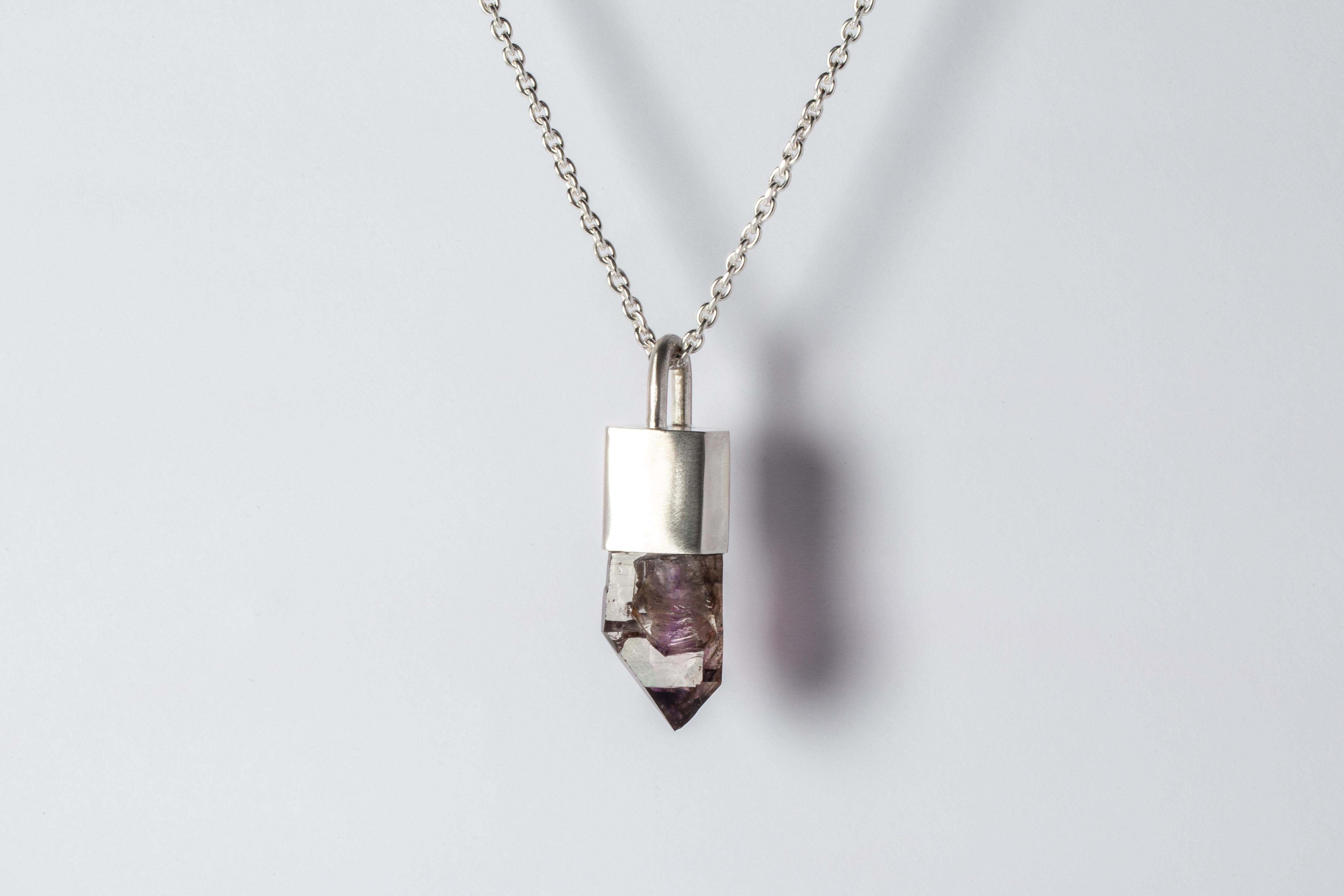 Talisman necklace in matte sterling silver and a rough of brandberg quartz. The Talisman series is an exploration into the power of natural crystals. The crystals used in these pieces are discovered through adventure and are hand selected. Each