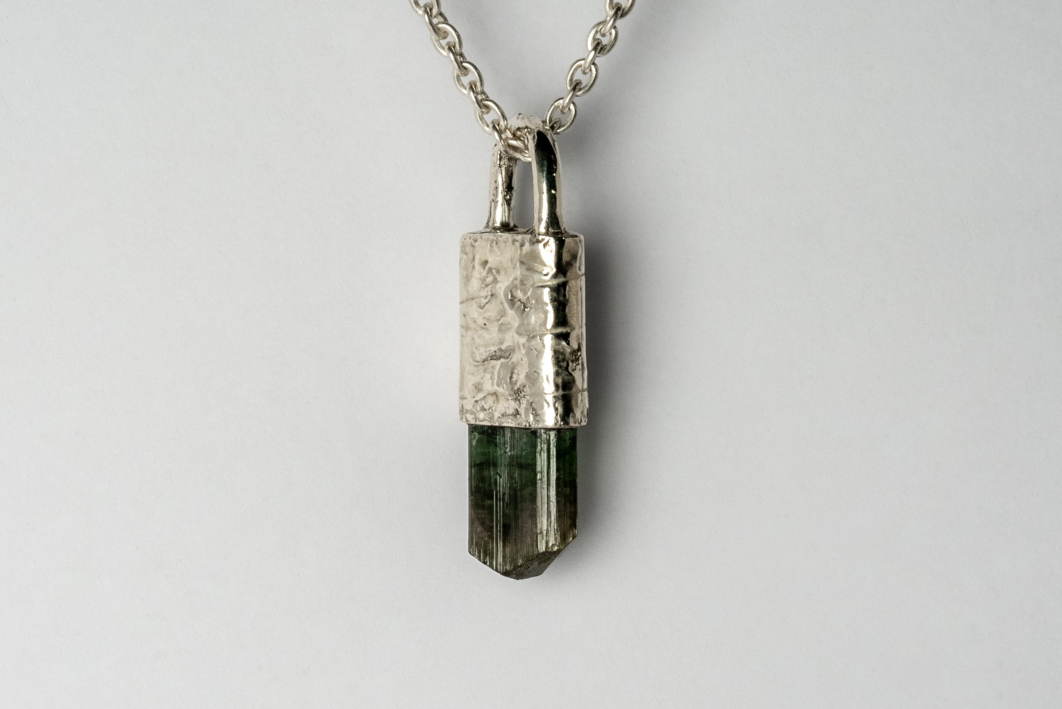 Necklace in matte sterling silver with fused layer of 10k white gold and a rough elbaite, range colors of tourmaline. The Talisman series is an exploration into the power of natural crystals. The title Specimen signifies a particular class of