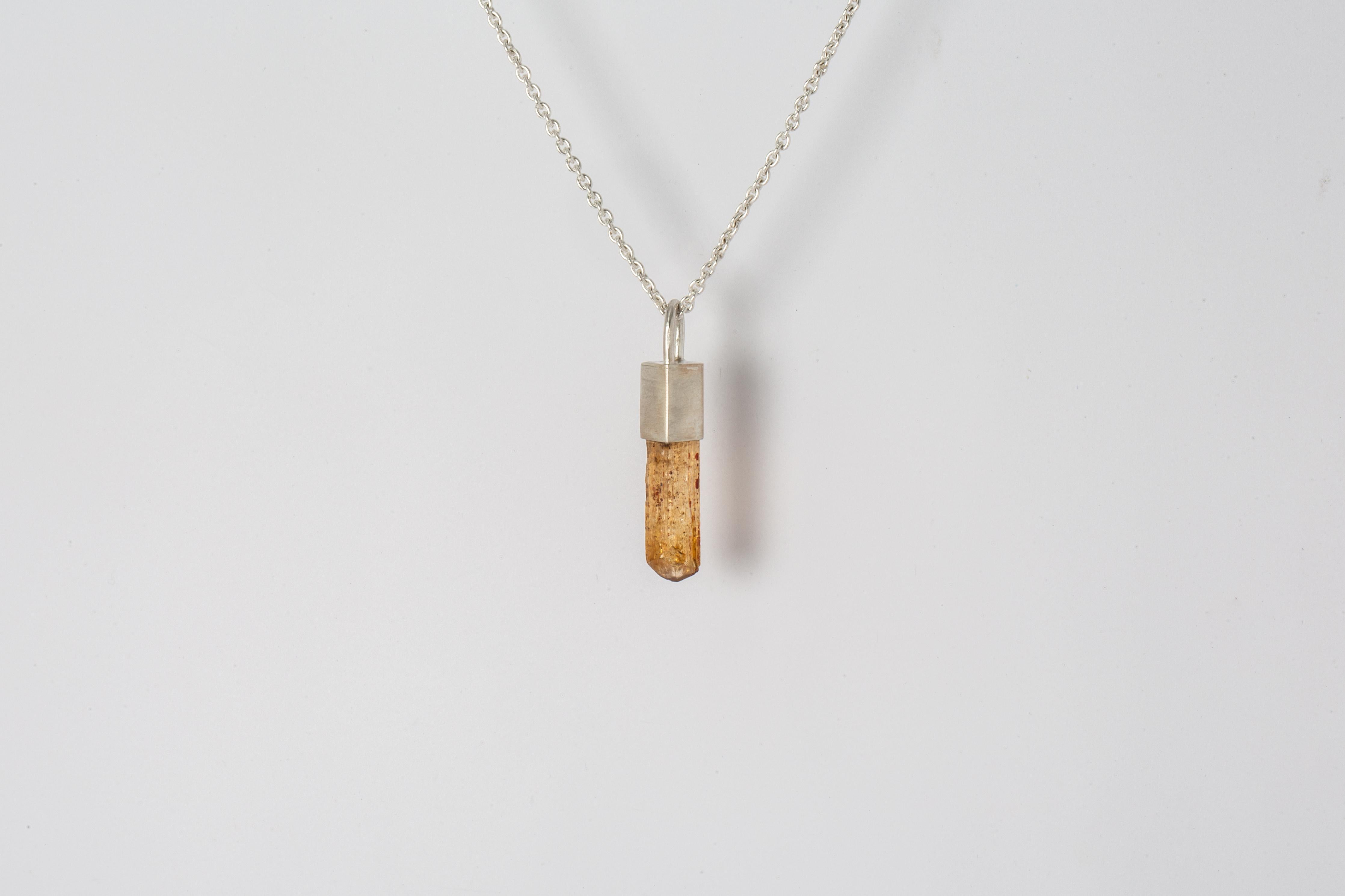 Talisman necklace in matte sterling silver and a rough of imperial topaz. The Talisman series is an exploration into the power of natural crystals. Each product with the status of Specimen has a unique number and is absolutely one-of-a-kind.