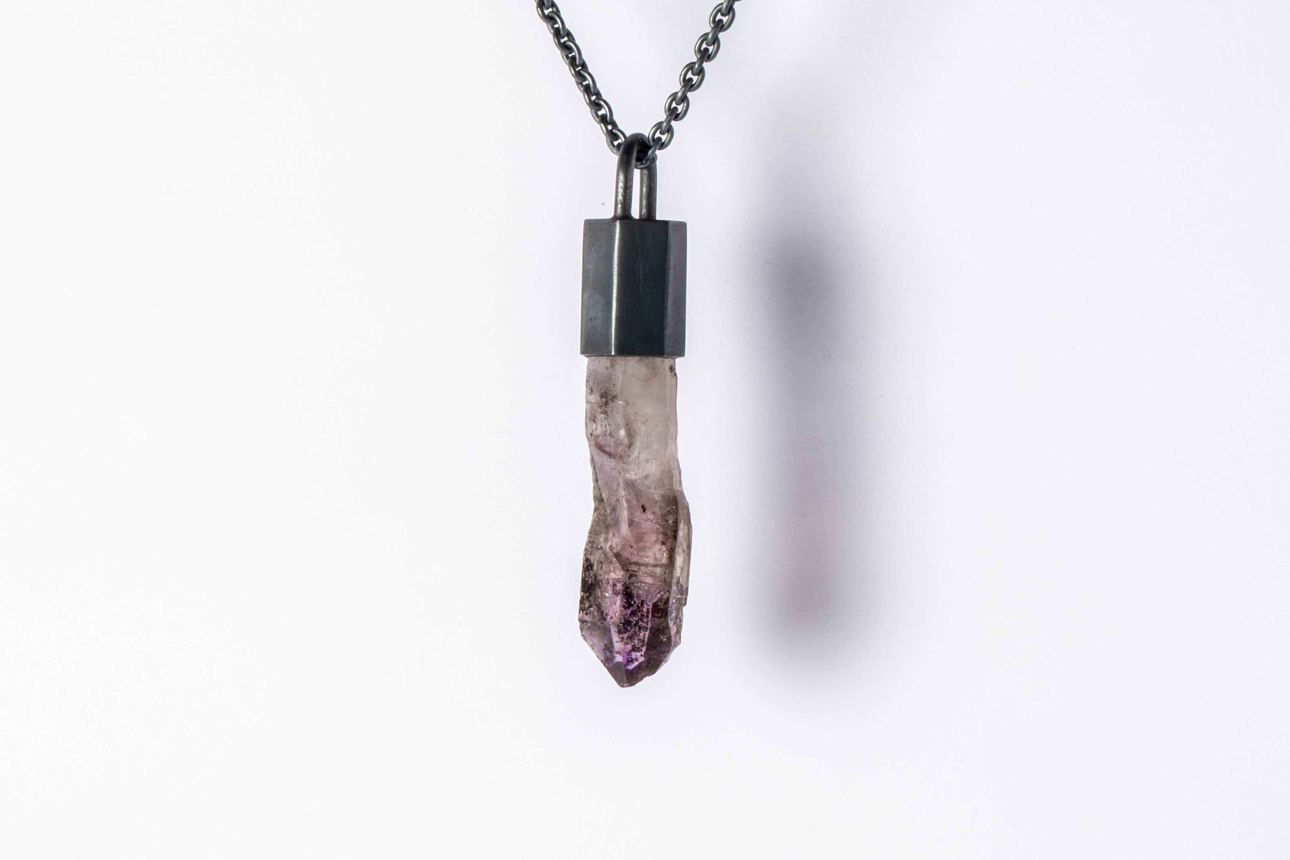 Necklace made in oxidized sterling silver and a rough of brandberg quartz. The Talisman series is an exploration into the power of natural crystals. The crystals used in these pieces are discovered through adventure and are hand selected. Each