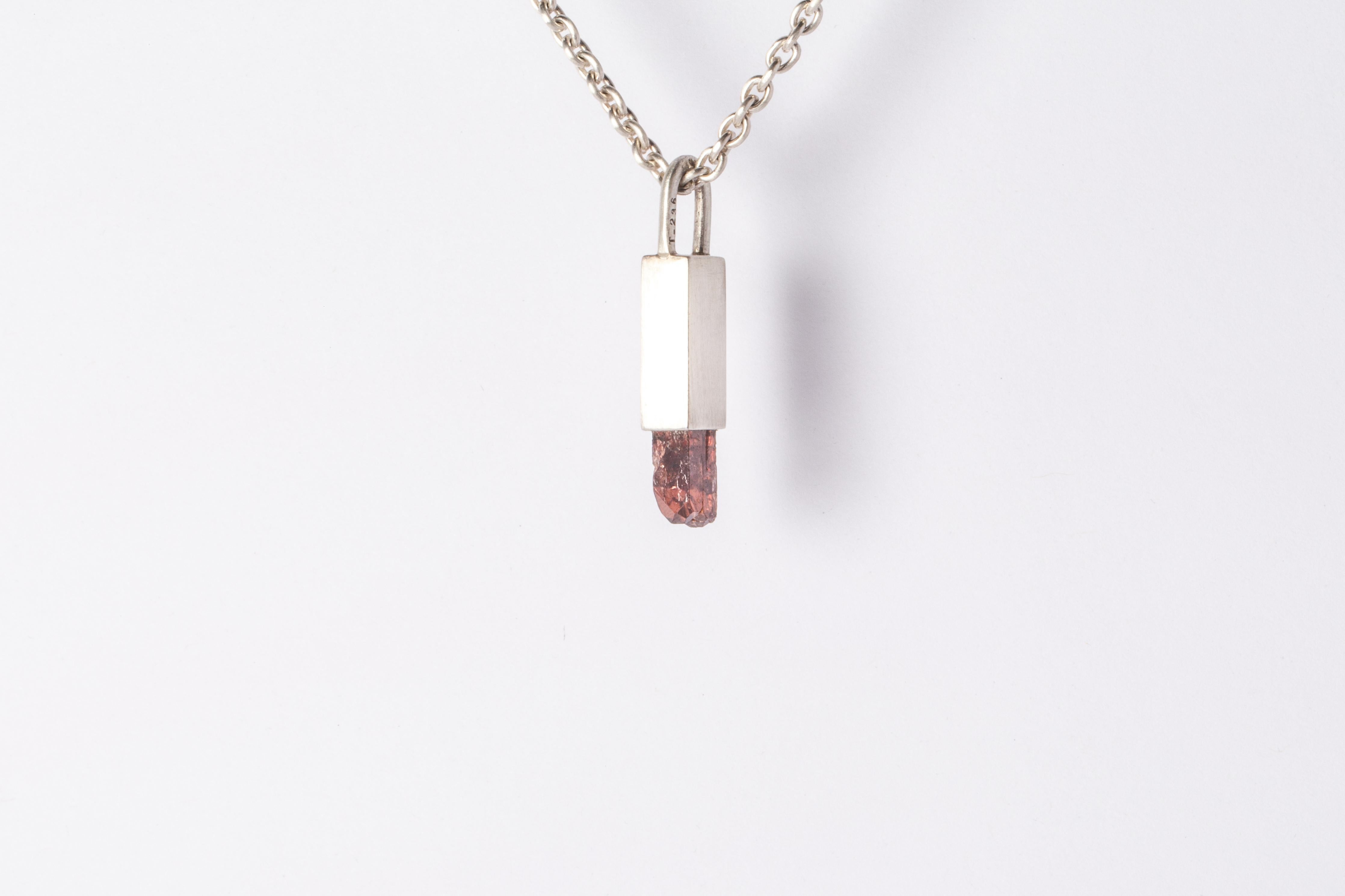 Necklace in matte sterling silver and a rough of zircon crystal. The Talisman series is an exploration into the power of natural crystals. The title Specimen signifies a particular class of mineral that is both rare and collectable. Each product