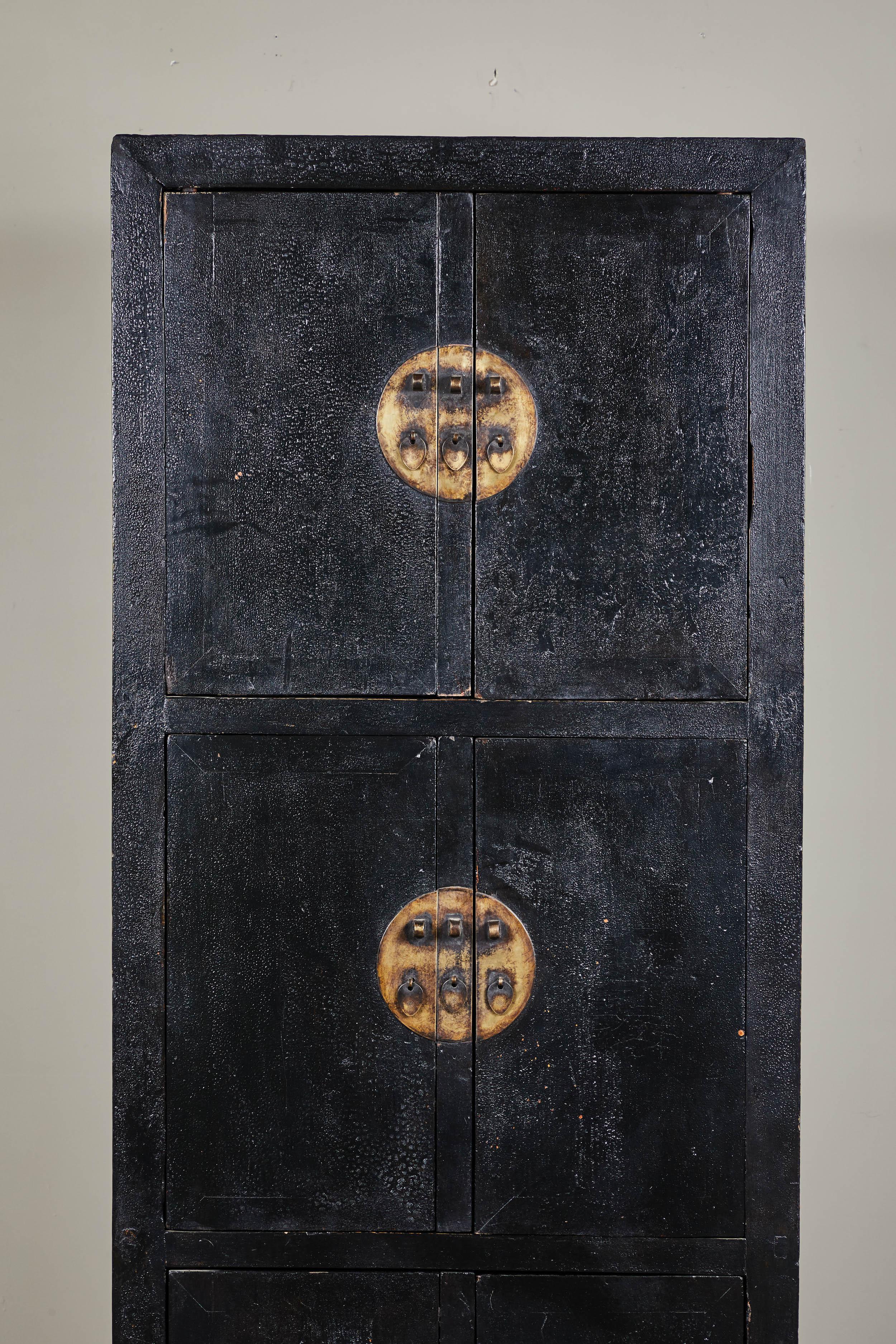 Tall 18th century Chinese black lacquer cabinet. A one-of-a-kind narrow six door tall cabinet with cracked black lacquer finish.