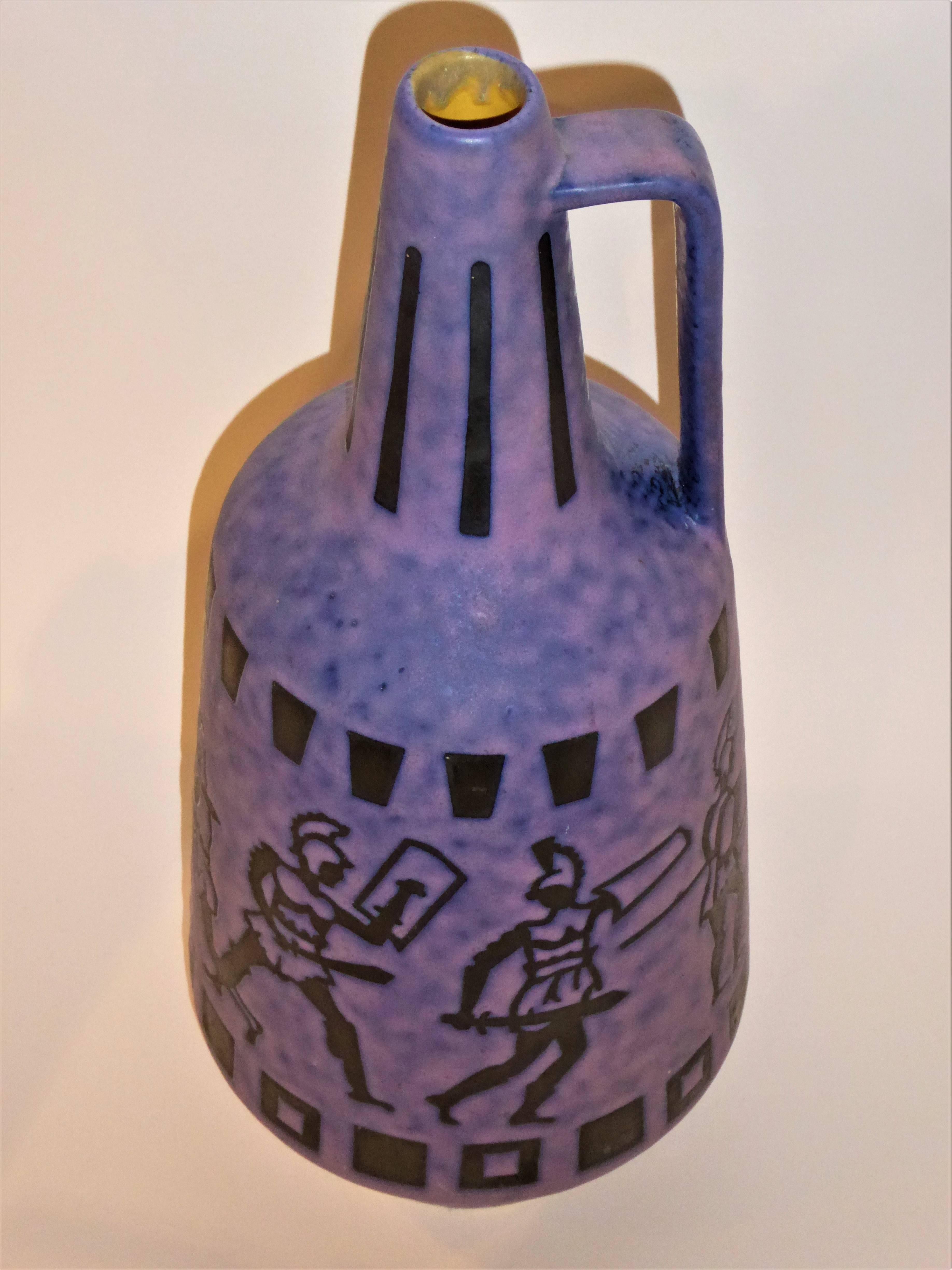 A 1960s midcentury tall vase ewer or krug in a mottled matte purple lava glaze with Roman Greco age fighting warriors depicted. Very Ceramano in design. Jopeko Keramik was founded in 1948 by Johann Peter Korzilius, hence the name, the first two