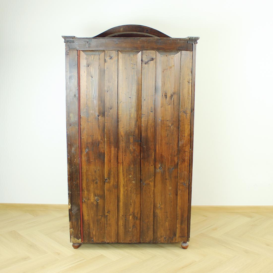 Beautiful and fully restored armoire. Produced in the end of 19th century in Czechoslovakia. Fully made of walnut wood. The armoire stands on four ball-like legs made of wood. The strong wooden doors with working lock hide 4 shelves inside. A
