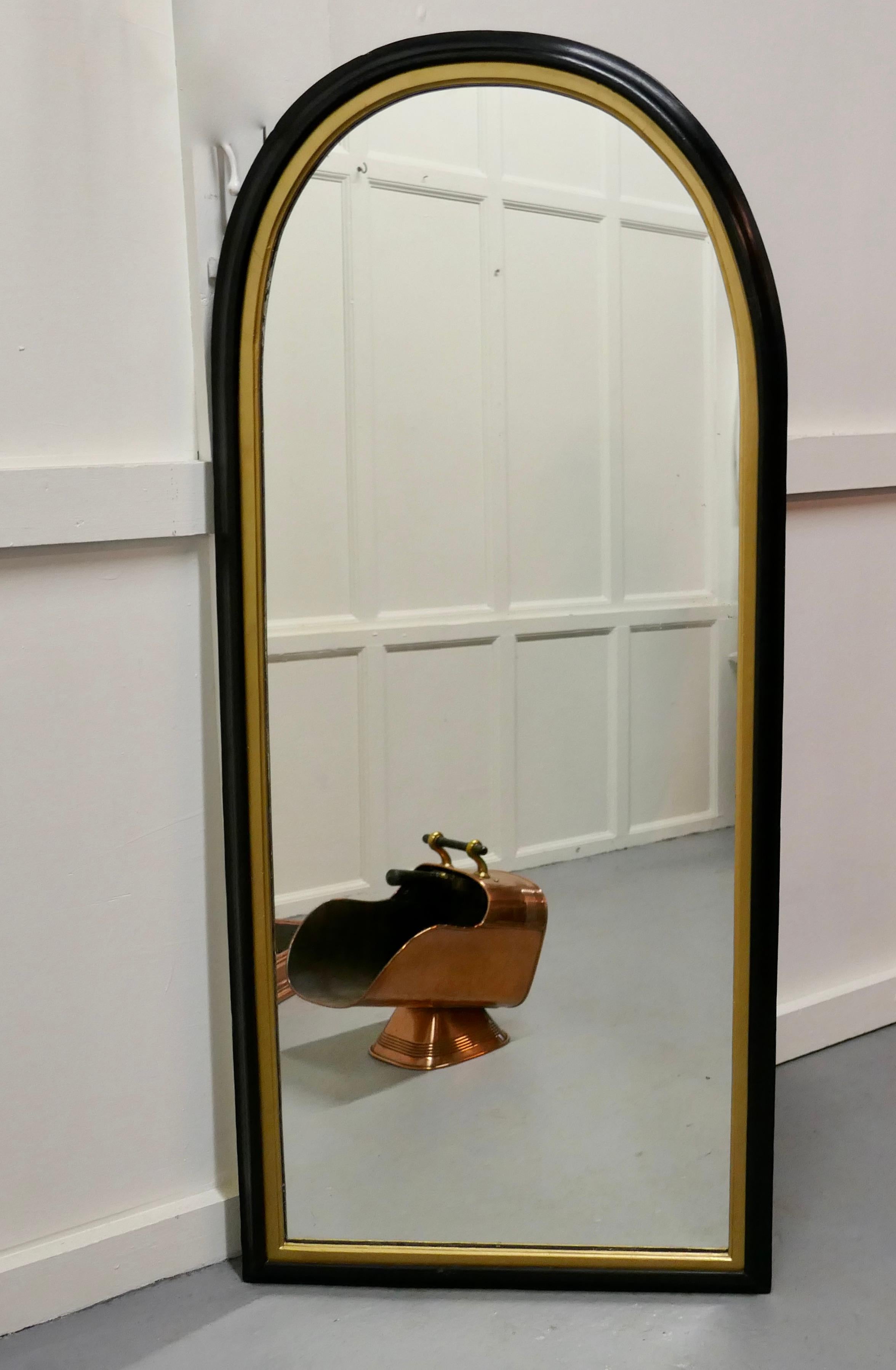 Tall 19th century black and gold arch top wall mirror

This is a charming wall mirror it is a tall slim piece with an arched top, the 3” wide mirror frame has a moulded shape and it is in black with a gold insert 
The mirror has has been a re