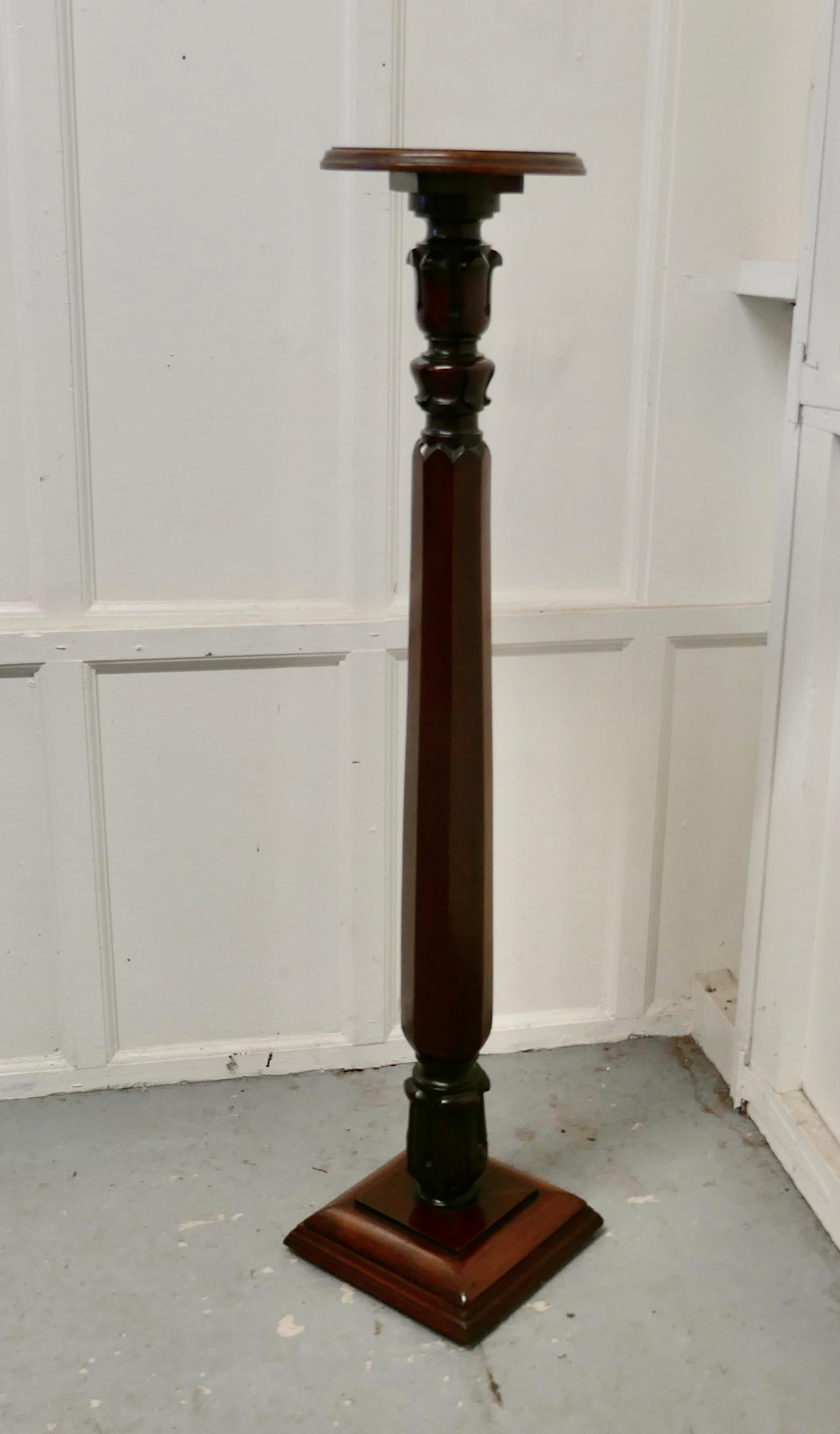 Tall 19th century carved mahogany pedestal

The column has an intricate tulip and acanthus leaf carvings top and bottom with a faceted section between 
The Torchere is very sturdy and decorated in the Classical style with have a multitude of uses
