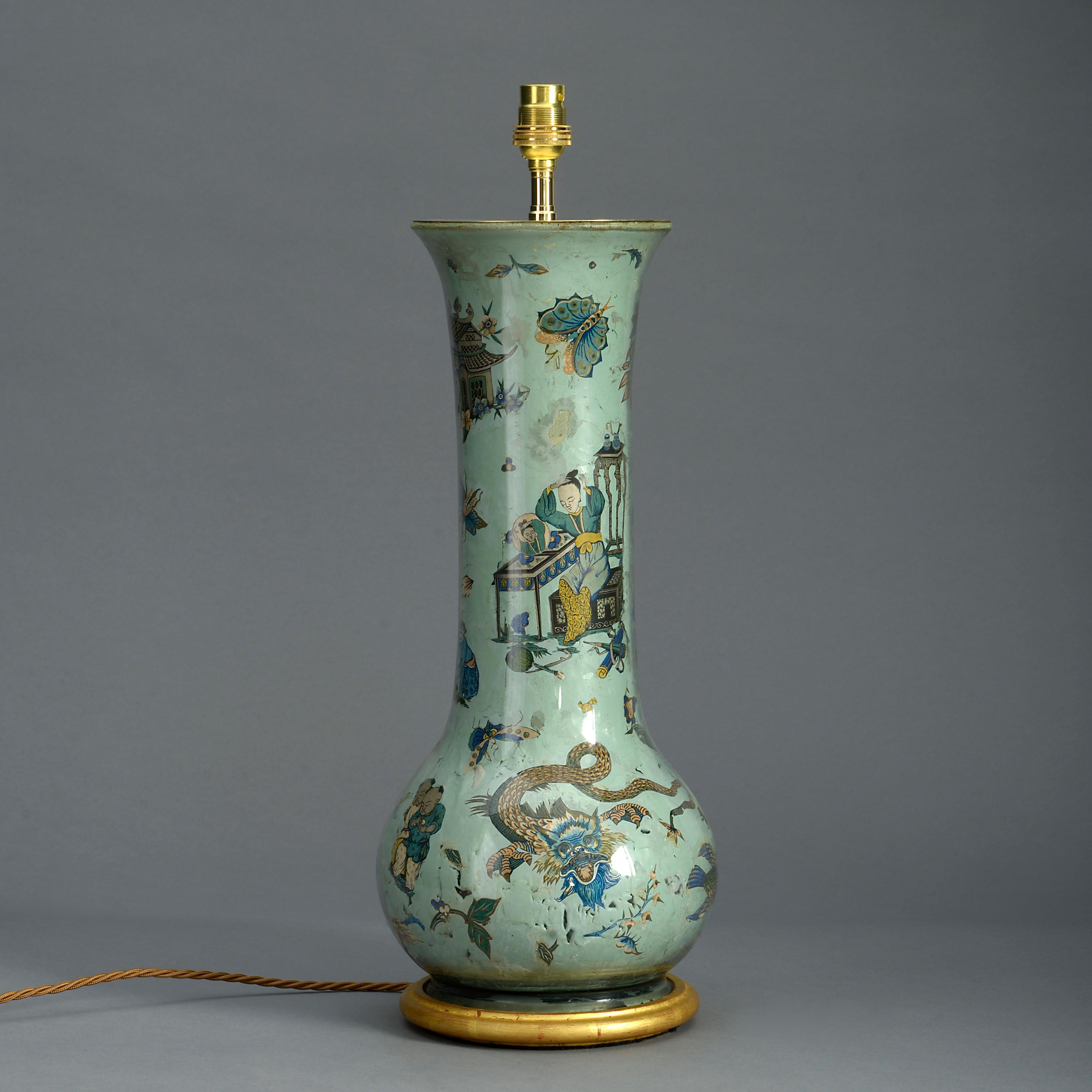 A 19th century tall Decalcomania glass trumpet vase of gourd form, decorated with polychrome chinoiseries upon a green ground. Now mounted on a turned giltwood base as a lamp.

Dimensions refer to vase and base only.

Not including shade.
