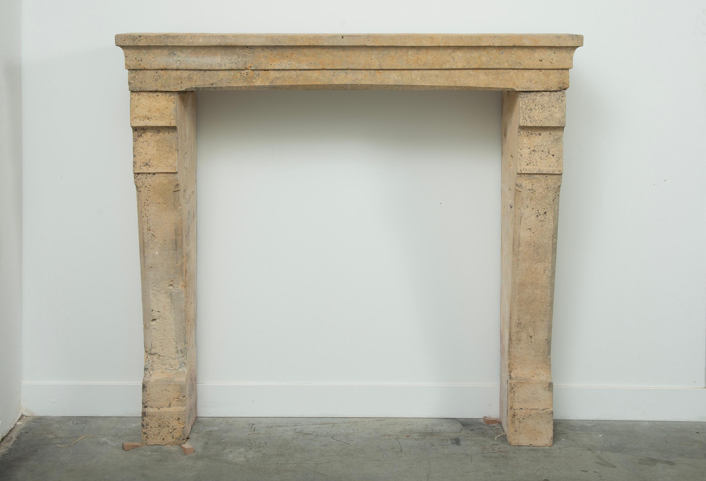 Tall 19th Century French Limestone Fireplace Mantel – Elegant & Robust

This tall 19th-century French limestone fireplace mantel blends refined elegance with architectural strength. 
Hand-carved from solid limestone, its clean lines, stepped