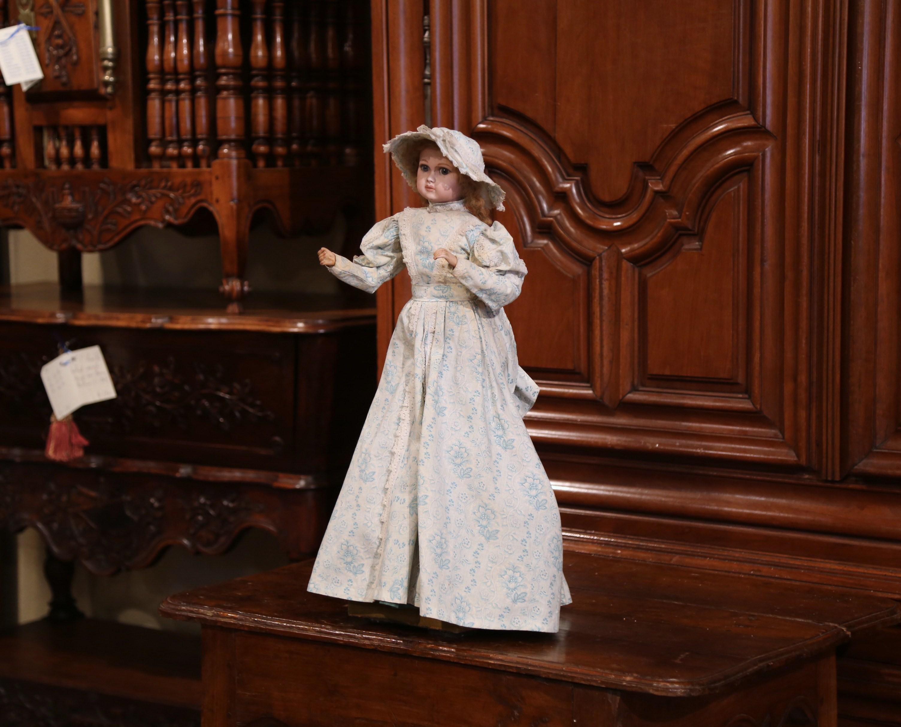 Here is a treasure for doll collector! This 19th century doll by Jumeau was crafted in France, circa 1870; the doll's head and right arm are in motion when the music is been played by cranking the knob on the base. The head and hands are made of
