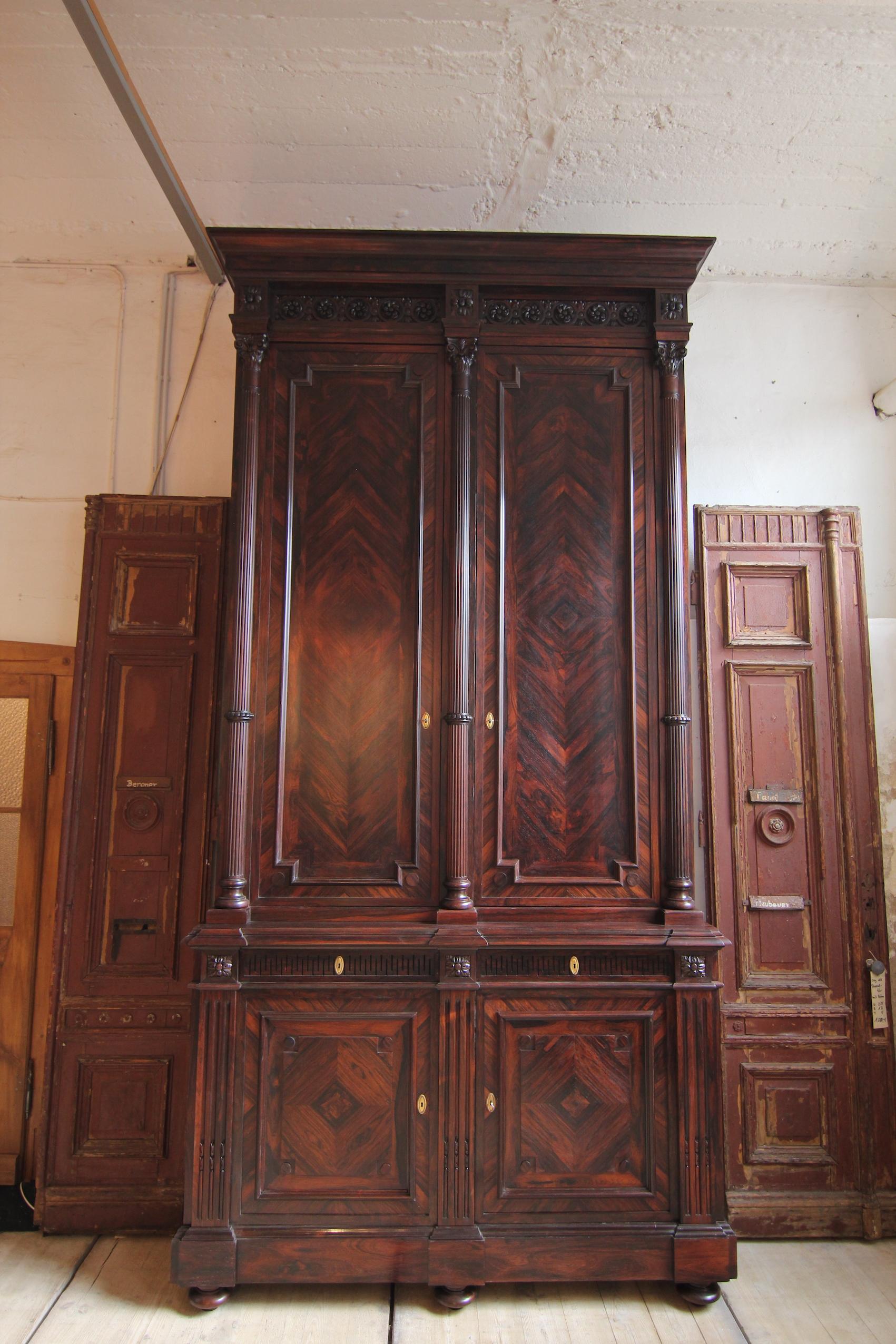 Probably the tallest cabinet on the market.
A breathtaking neoclassical palisander cabinet from the 19th century. Presumably of French origin.
Solid rosewood and veneered on oak.

The cabinet is architecturally structured vertically by three