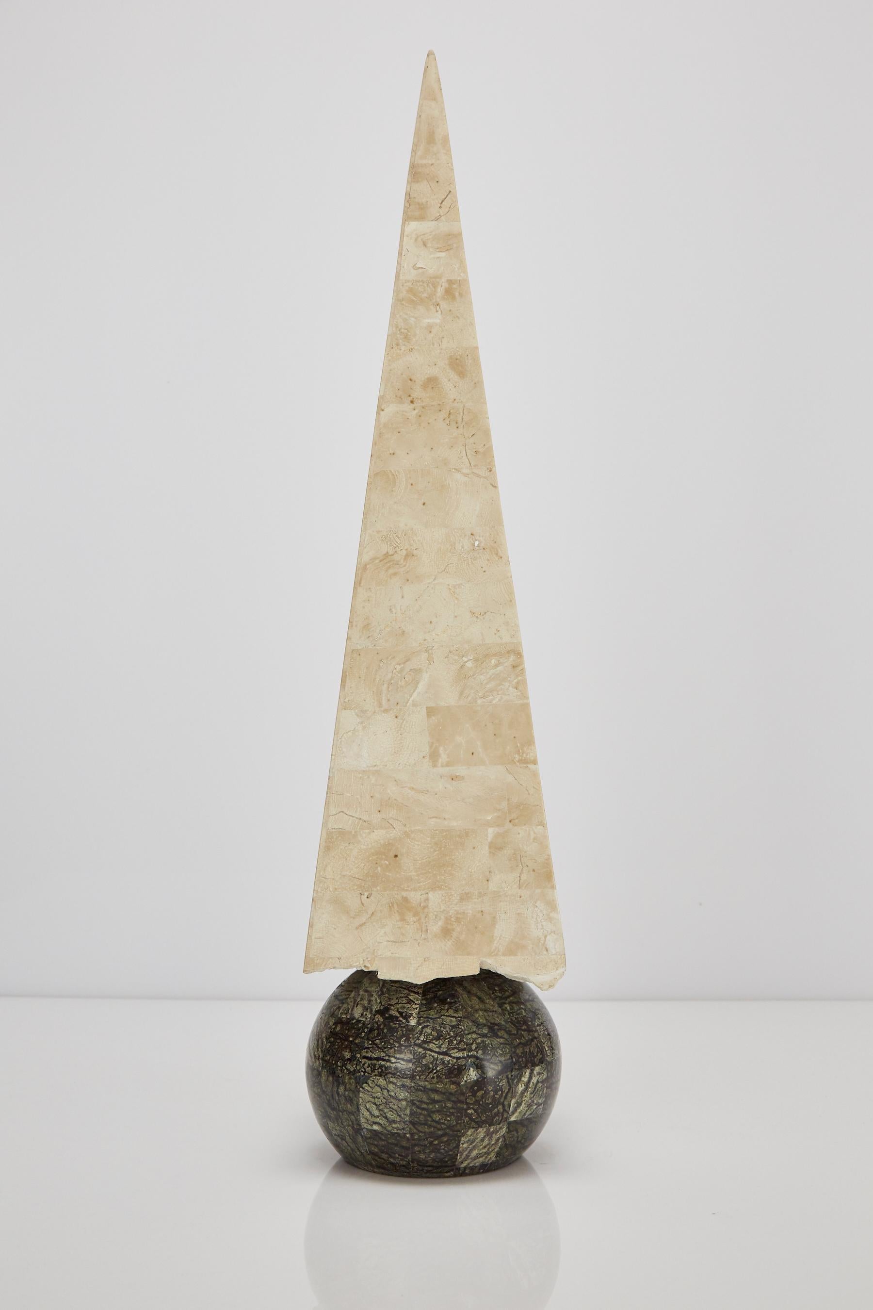 Tall 32 in. tall decorative obelisk. The pyramid executed in tessellated beige fossil stone and round base executed in Serpentine stone. 

Coordinates with items LU1484211449871 and LU1484211449861 for a set of three.

All furnishings are made from