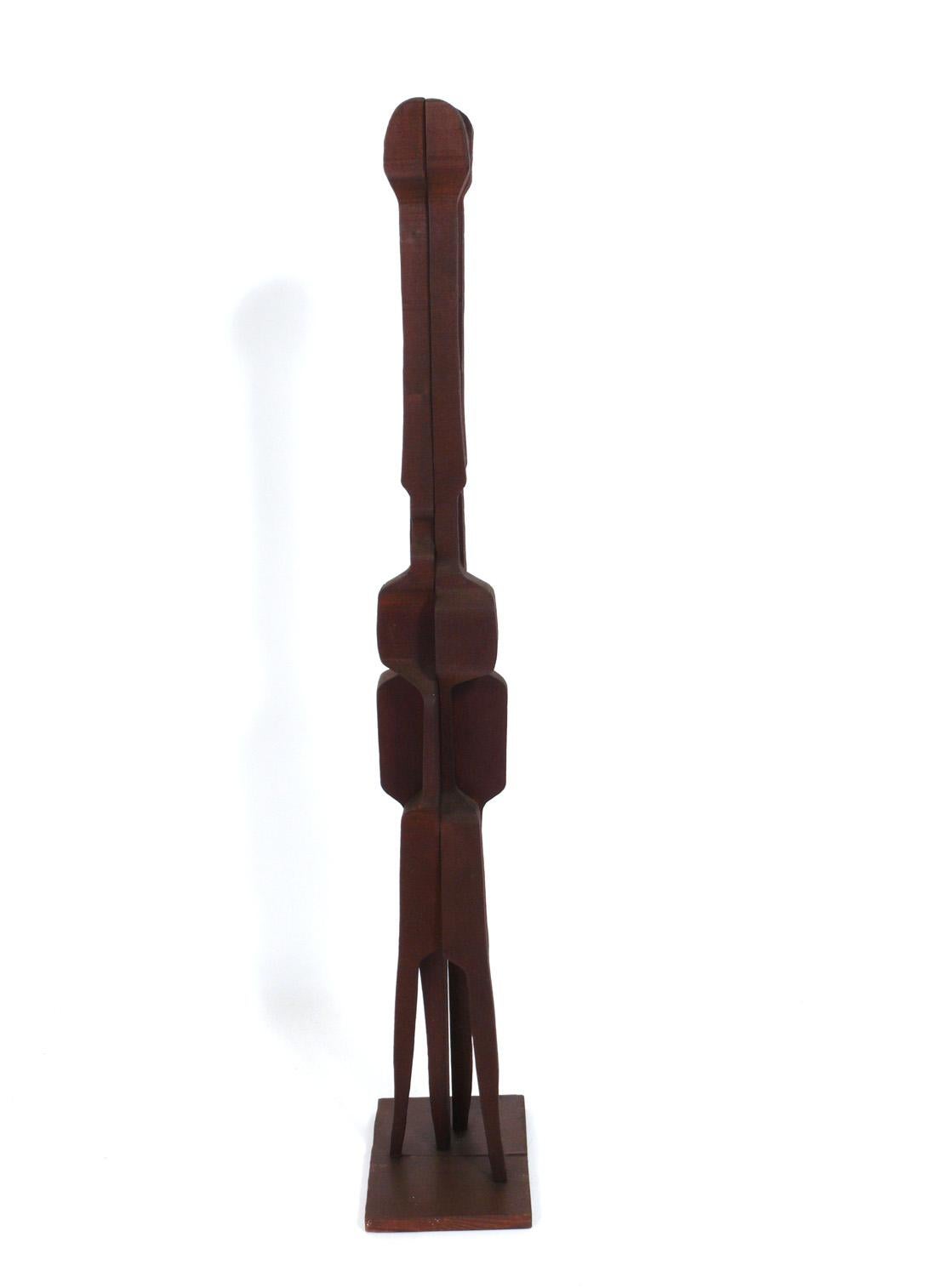 Tall abstract wood sculpture, artist unknown, probably American, circa 1950s. It stands an impressive 49