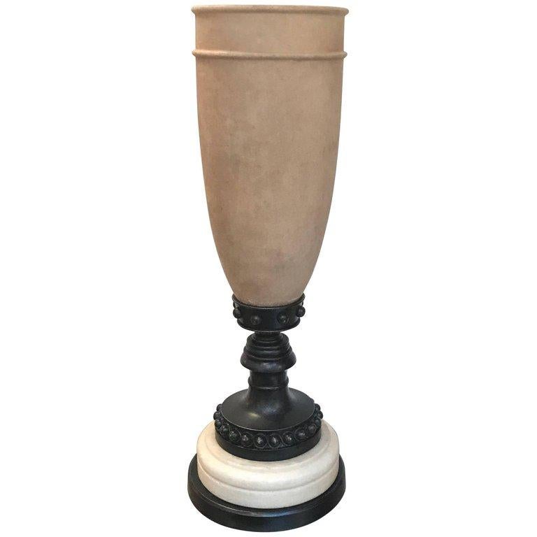 Striking tall table lamp with urn form textured alabaster shade. When lit this lamp gives a warm illumination to the stone and soft up lighting. The base in a patinated bronze and alabaster.