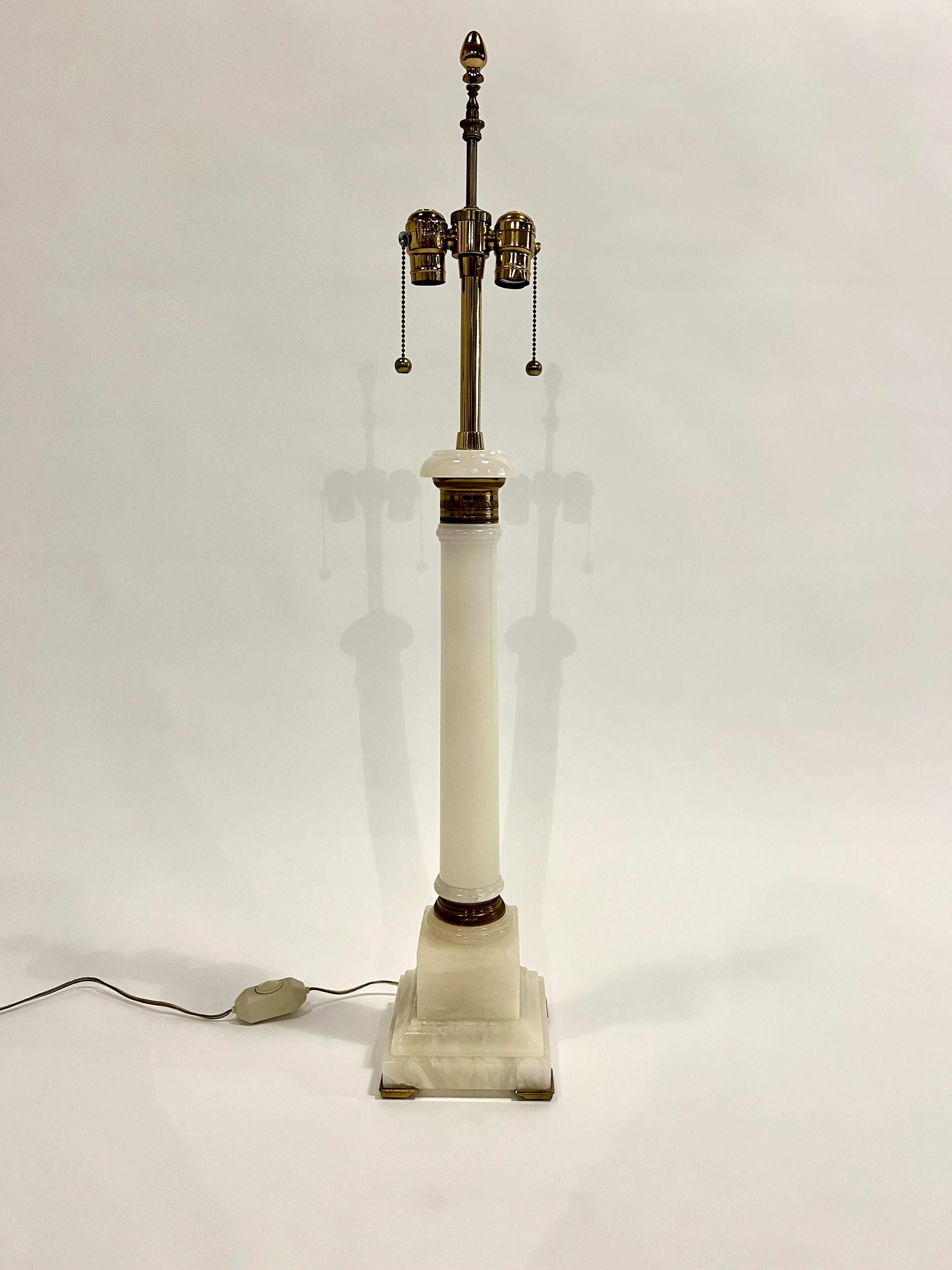 Tall classical column lamp in alabaster and brass accents attributed to Marbo Lamp Co. Comes with original silk lined shade and brass finial.