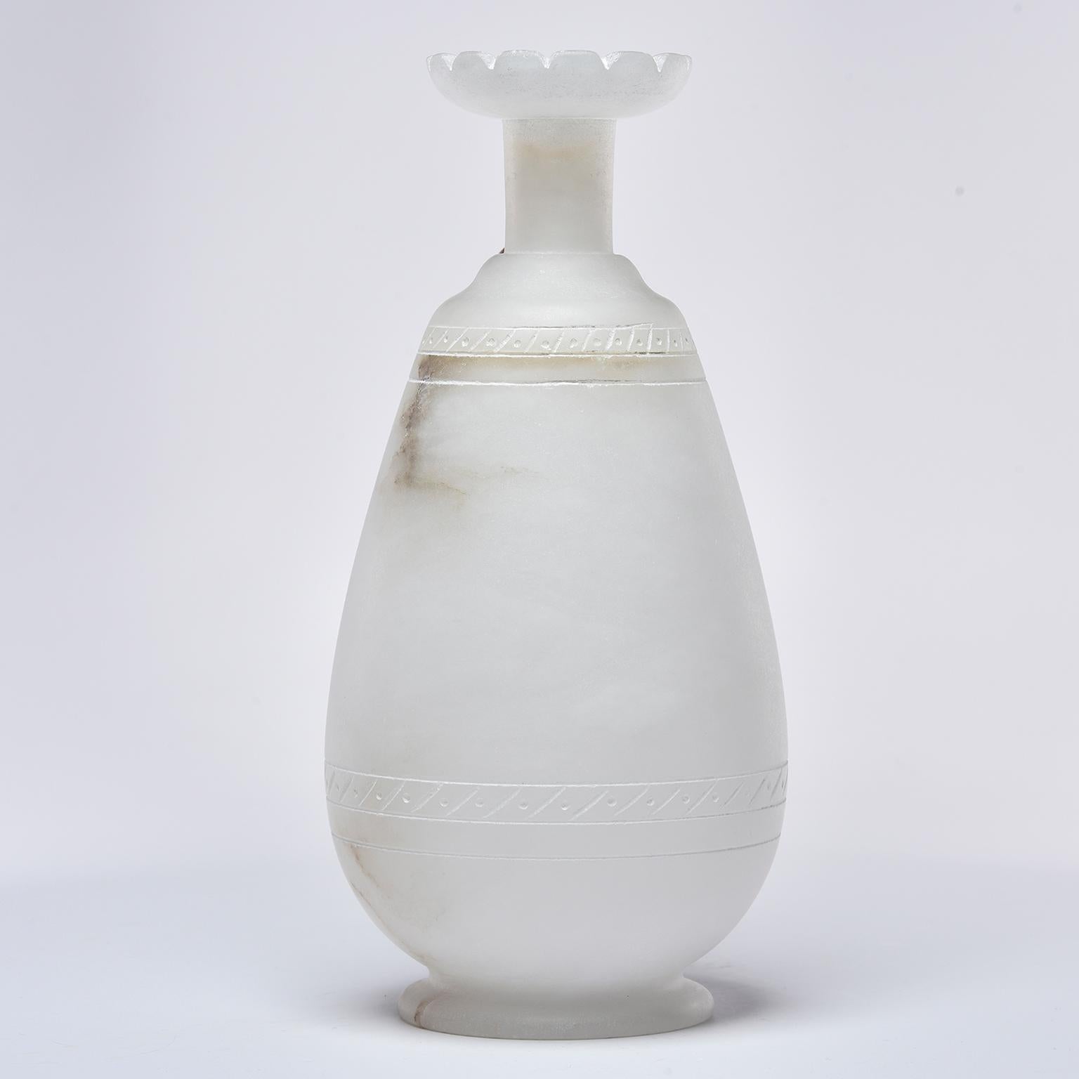 New Italian-made alabaster ewer in pale cream colored alabaster with narrow neck, fluted rim and contrasting brown alabaster handle. Decorative hand carved bands near top and base.
