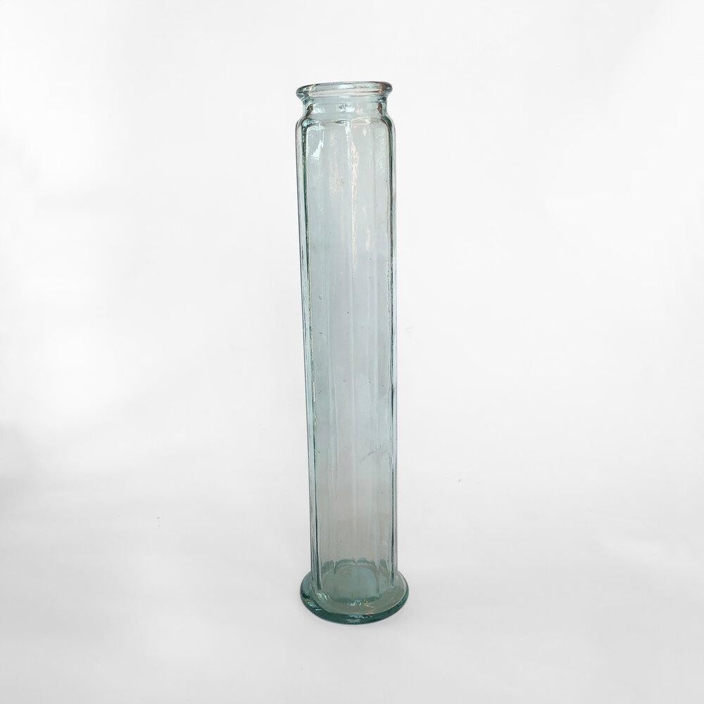 A very tall handblown glass vase from ALBI, in the manner of traditional apothecary jars. The vase has a clear green colour and a polygonal round shape, bending on one side like the Pisa tower (as seen on pictures).

Creator: ALBI Glass

Place