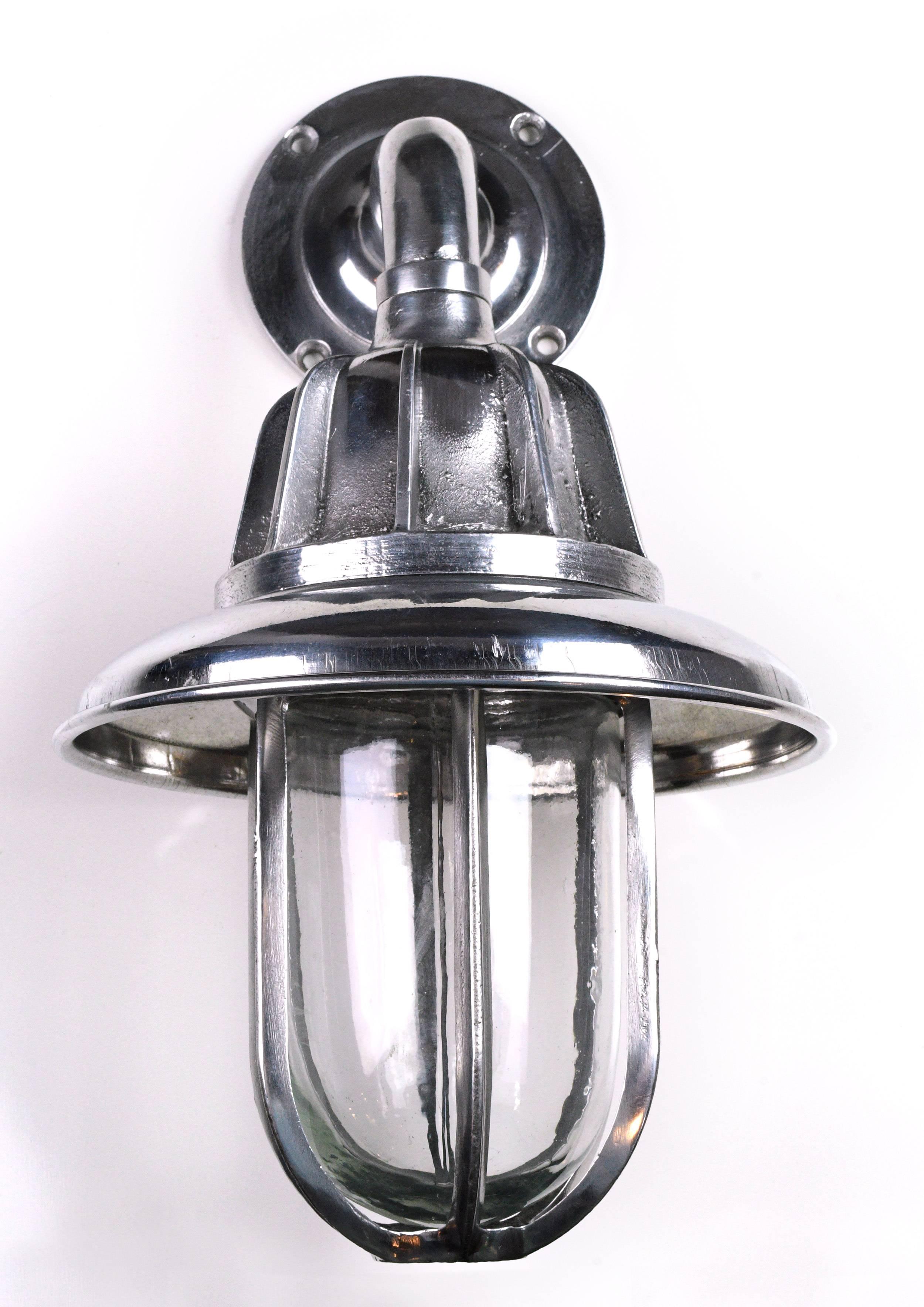 Shiny cast aluminium nautical sconce in like-new condition. Comes with removable hood, giving you two distinct looks. The perfect fit for any number of design styles: think sleek Industrial, modern, and maritime-inspired. 

Search for item number