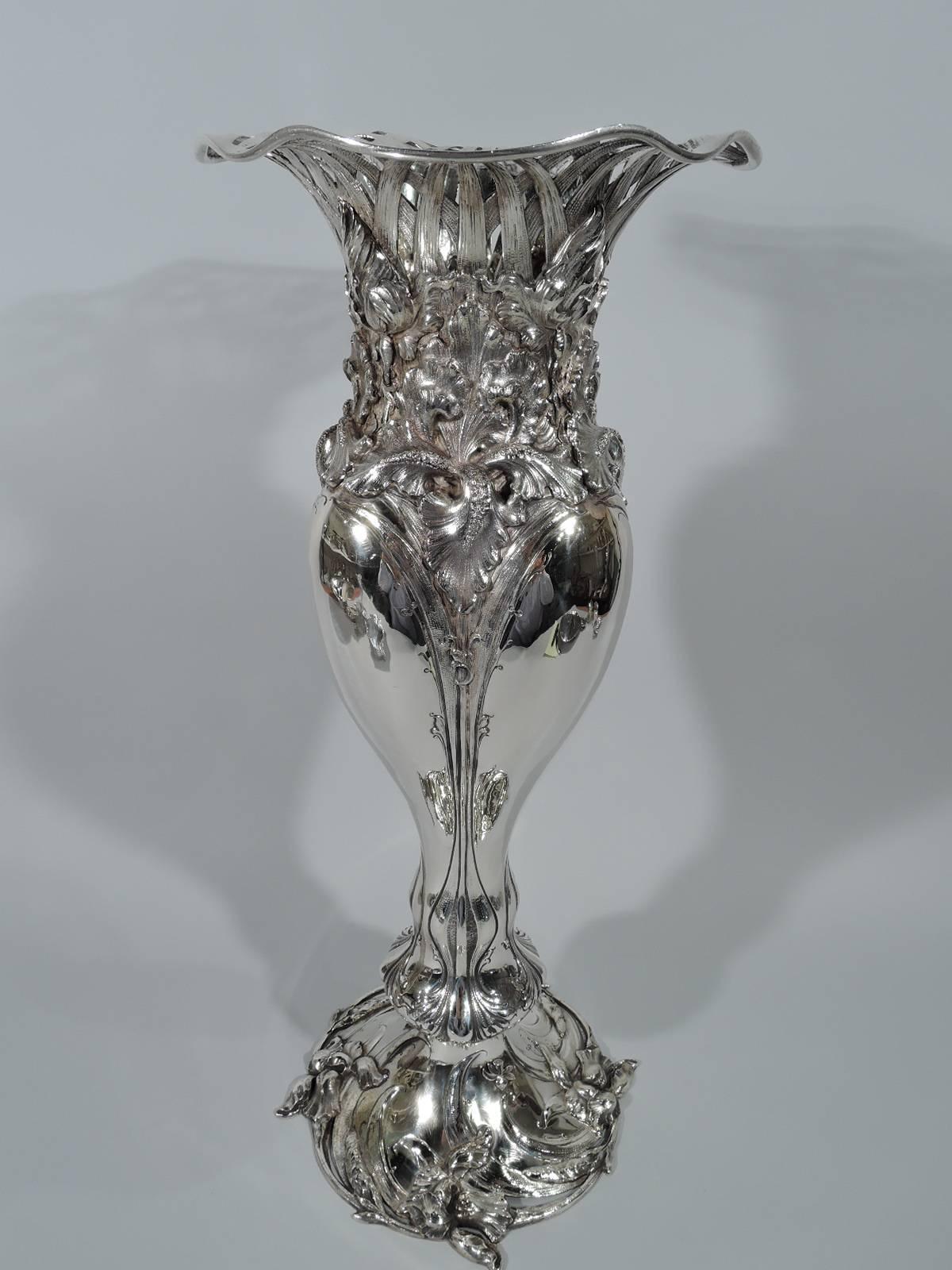 American Art Nouveau sterling silver vase, circa 1890. Undulating baluster vase with stem-framed lobes, wavy rim, and domed foot. Chased and repousse floral ornament: Splayed and overlapping irises with swooping leaves. Top in form of open