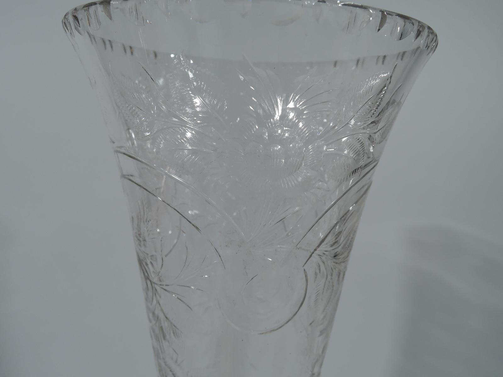 American Edwardian sterling silver and crystal trumpet vase, circa 1910. Clear crystal with etched flowers and overlapping strapwork arcade. Notched egg-and-dart rim and fluting at bottom. Domed sterling silver base. Hallmark includes Fifth-Avenue