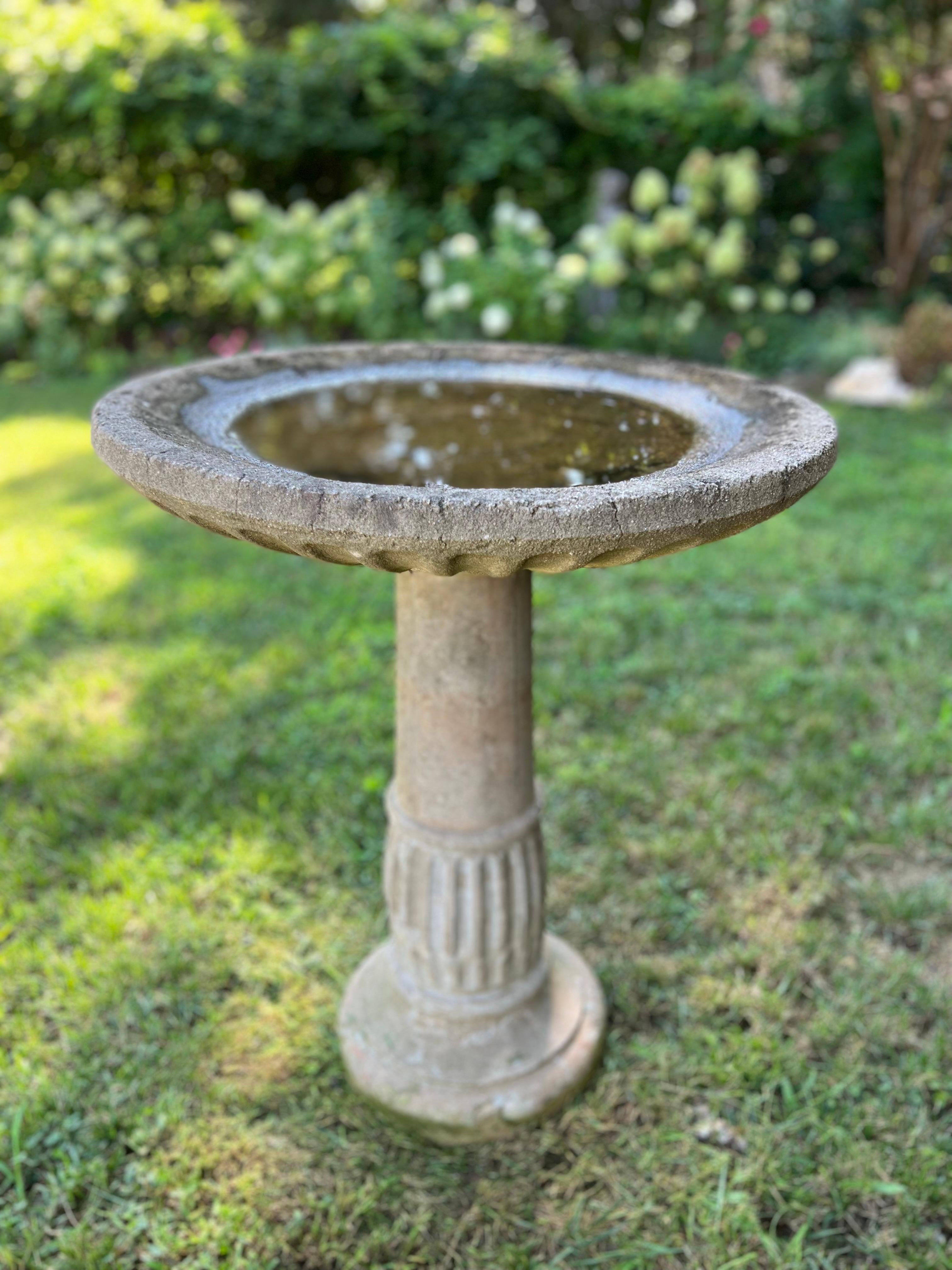 Beautiful cast stone birdbath. A bit taller than usual giving it an elegant statement.
Overall great antique condition with aged patina. 
Adds a touch of elegant interest to any outdoor space.