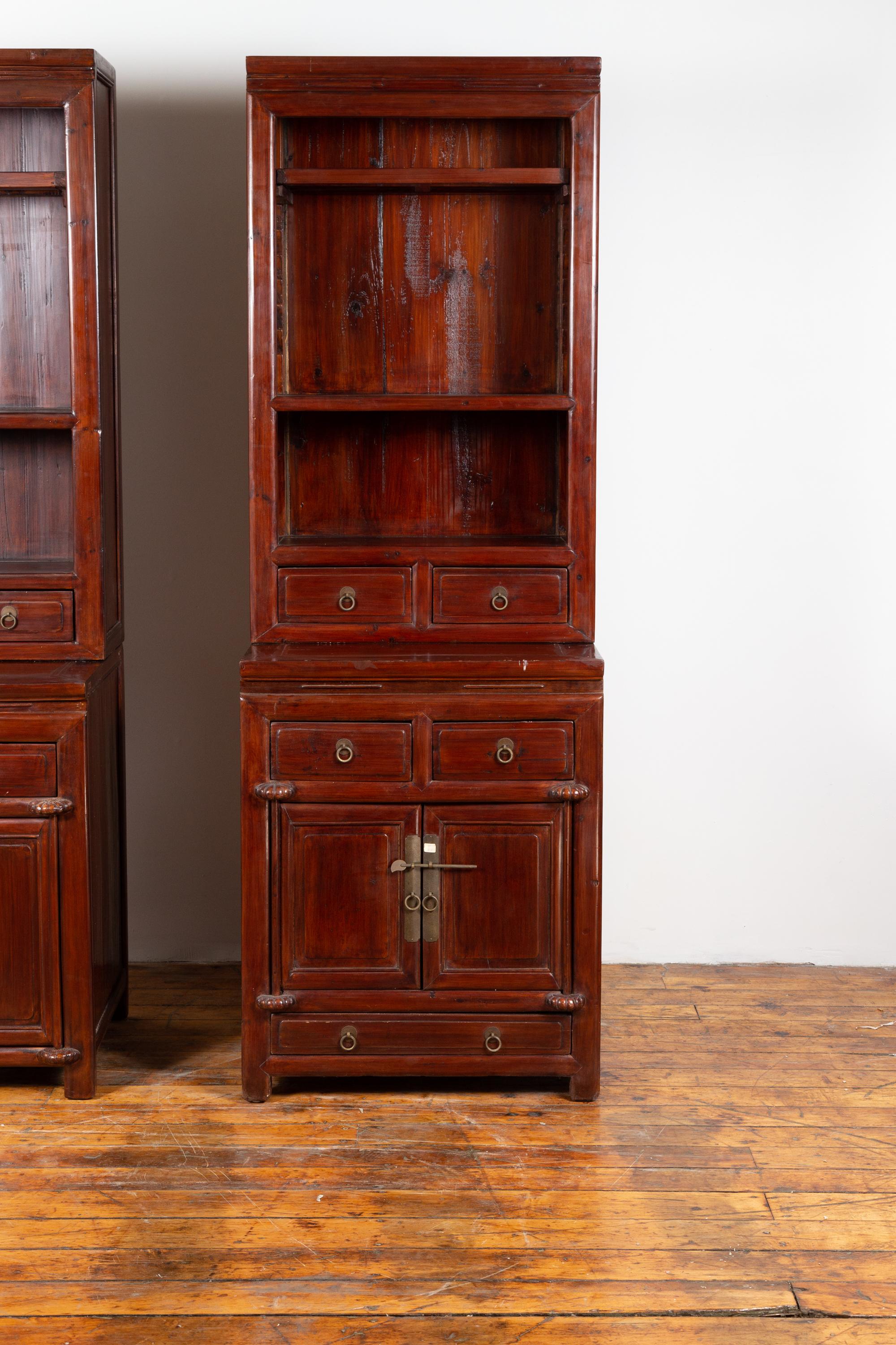 A tall Chinese antique two-part wooden lacquered cabinet from the early 20th century, with open shelves, doors and drawers, perfect to work as a pair with its twin (see item LU863916021382). Born in China during the early years of the 20th century,