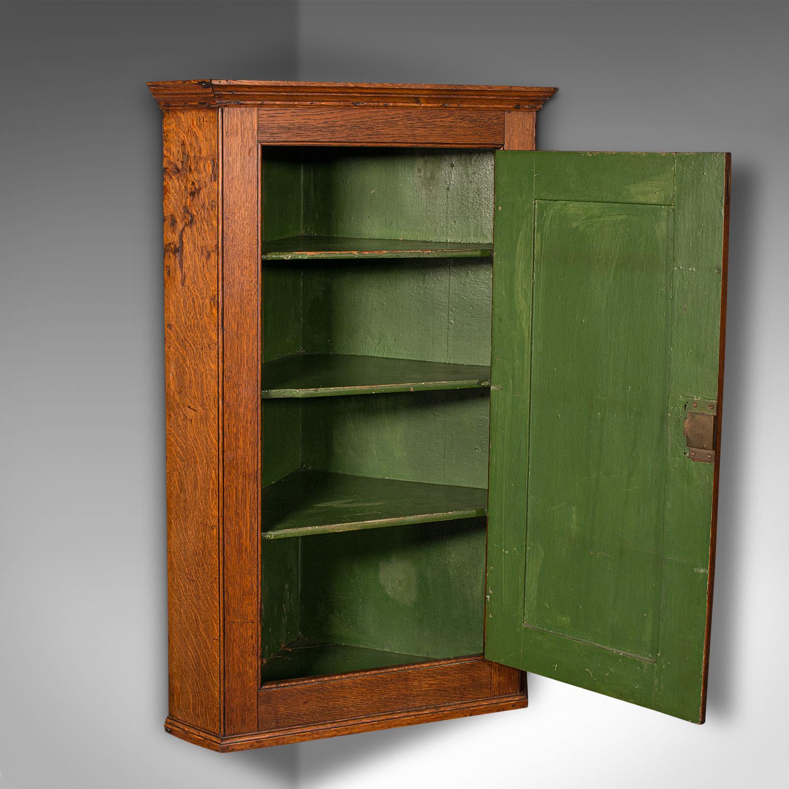 
This is a tall antique corner cabinet. An English, oak four shelf wall cupboard, dating to the Georgian period, circa 1800.

Superb period cabinetry with country house appeal
Displays a desirable aged patina and in good order
Select oak presents