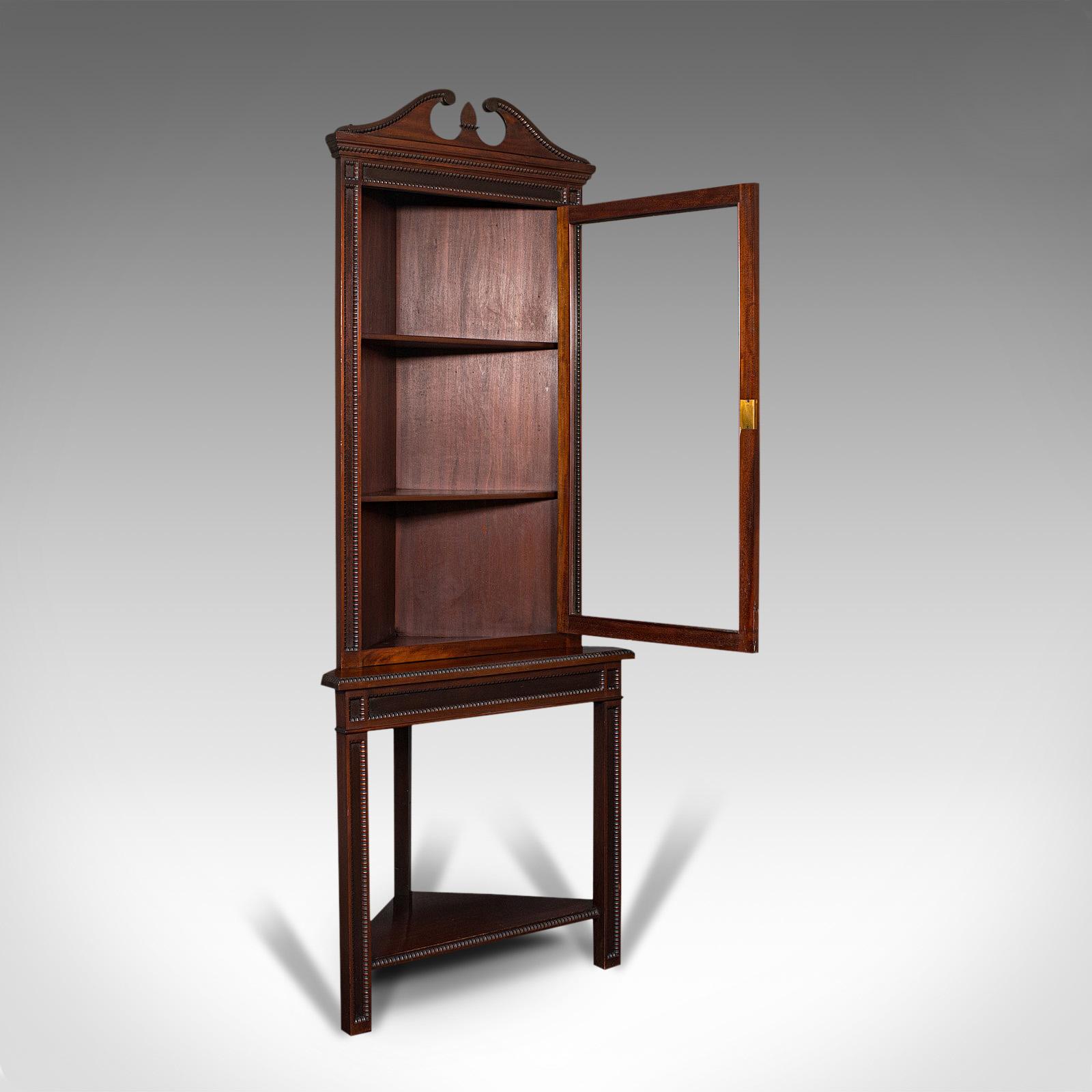 This is a tall antique corner cabinet on stand. An English, mahogany display cupboard, dating to the Edwardian period, circa 1910.

Of generous proportion, standing at 6' 52