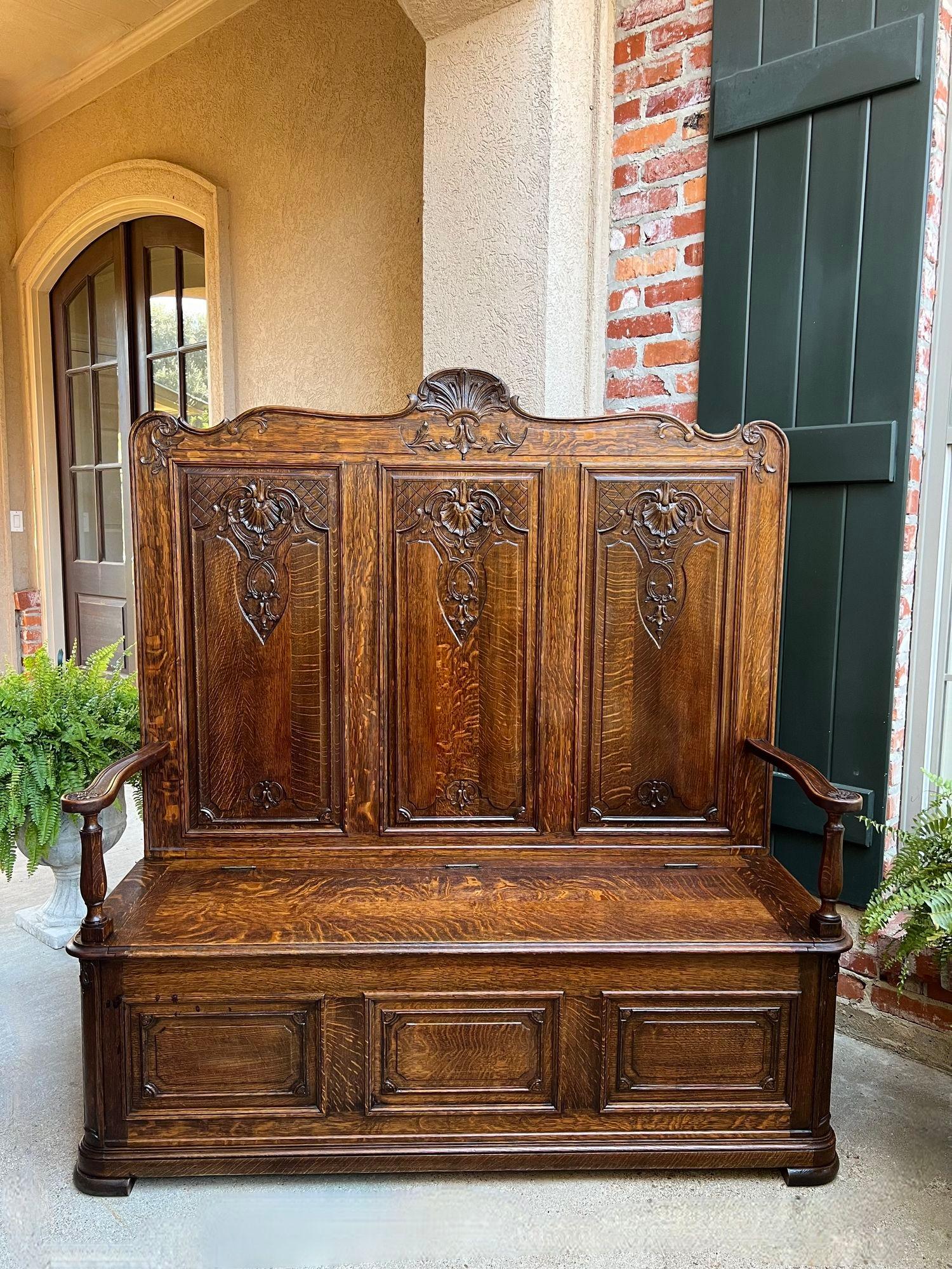 TALL Antique French Louis XV Bench Settle Pew Carved Tiger Oak Chest Foyer Entry Piece.

Direct from France, a stunning antique French hall bench with superb carvings and a majestic 5 ft. height!
Louis XV design throughout, with carved shell center