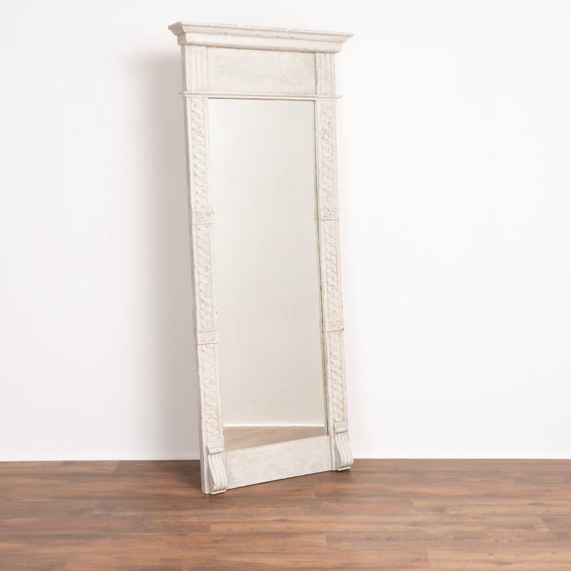 This 6' tall mirror is made even more striking due to the newer, professionally applied grey painted finish which accents the decorative side carvings. Please enlarge photos to appreciate the texture of the white and gray paint blended together