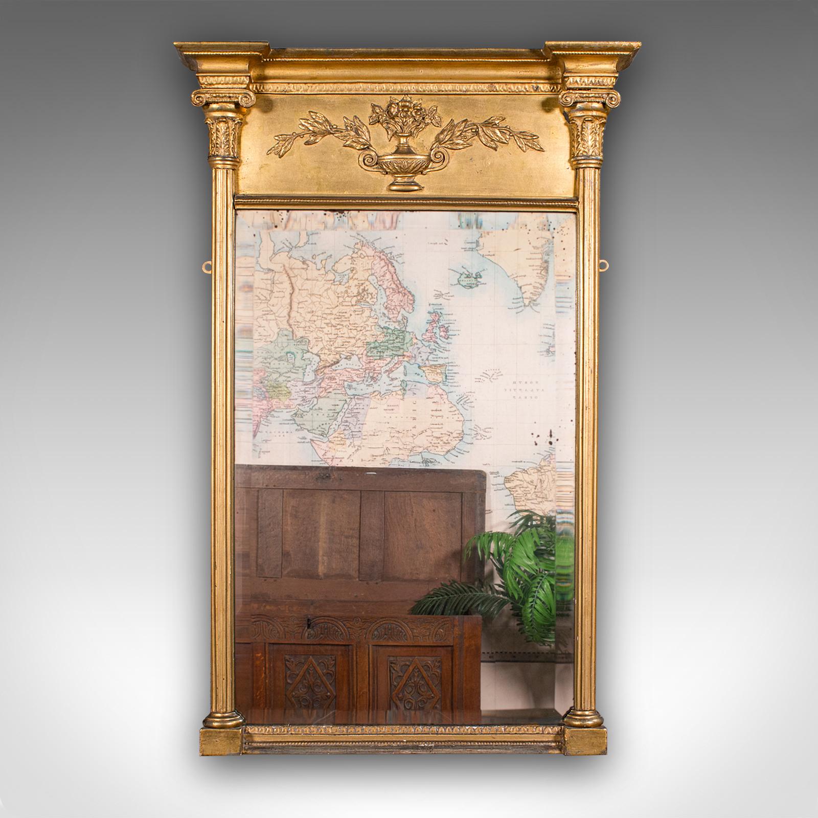 This is a tall antique pier mirror. An English, giltwood bevelled wall mirror, dating to the late Georgian period, circa 1820.

Visually striking frame and bright reflection to this fine Georgian example
Displays a desirable aged patina and in good
