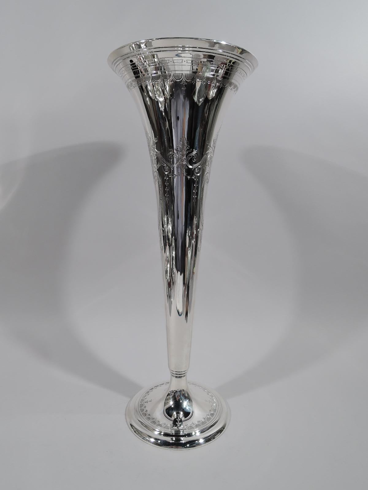 Tall sterling silver centerpiece trumpet vase. Made by Tiffany & Co. in New York, ca 1913. Conical on stepped and raised foot. On front and back engraved armorial cartouches (vacant). Stylized leaf-and-dart and block borders. A bold and Modern form