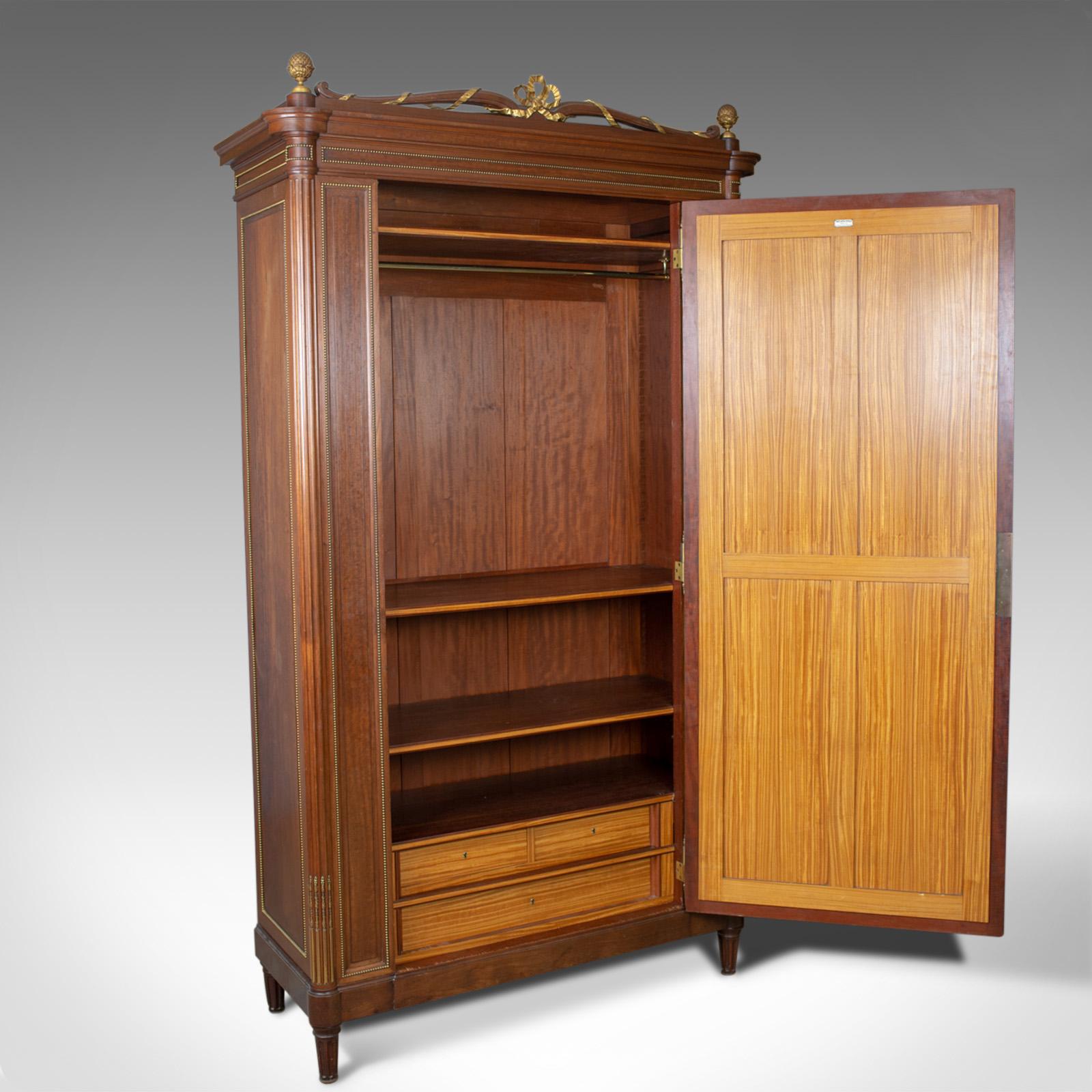 This is a tall antique wardrobe. A French, mahogany armoire in the Louis XVI taste by renowned cabinet maker Constantin Potheau of Paris and dating to the early 20th century, circa 1910.

Of superior quality by a fine cabinet maker
Constantin