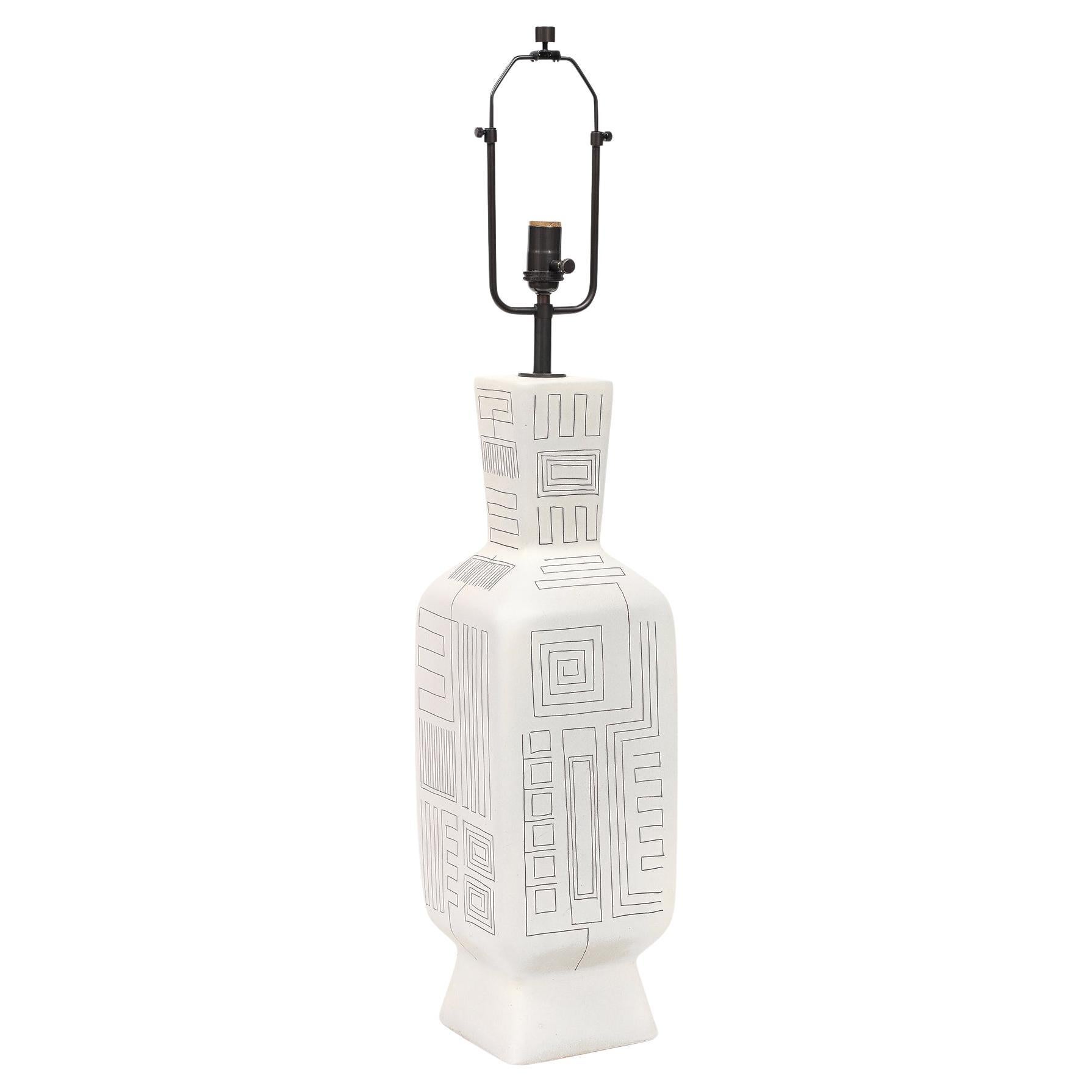 Tall Architectural Table Lamp, Ceramic, Incised, Abstract, Geometric. 
A tall, architectural ceramic lamp with a flared neck, squared shoulders, elongated rectangular body with incised geometric patterning, and a solid truncated-pyramid base. The