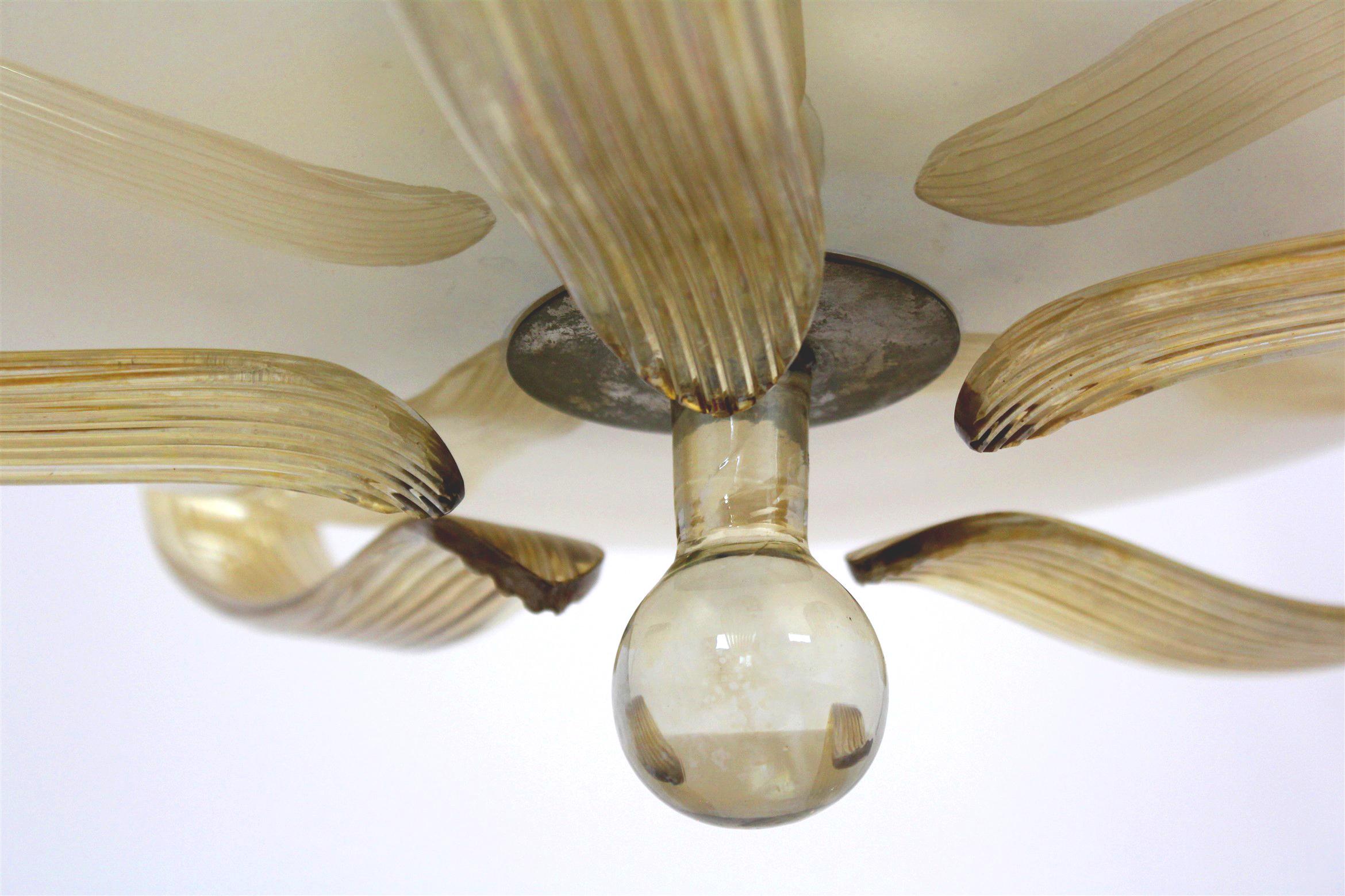 
This Art Deco style chandelier was manufactured by ESC in the 1940s.
Made of brass and curved glass, kept in original, good condition.