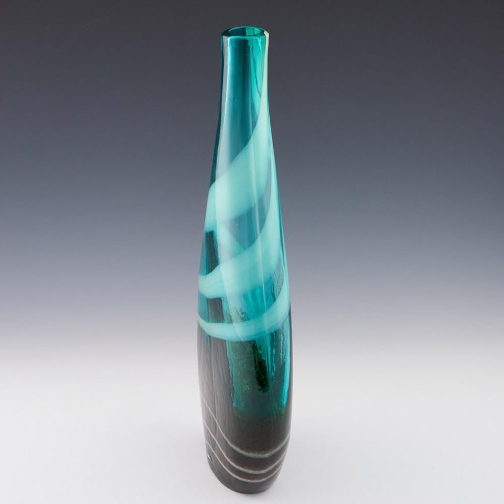 Tall art glass vase made c200 most likely Teign Valley Glassworks, Devon
Bowl Features : broad oval profile and oval in section; tapering towards small, round aperture; turquoise/green with white trails and grey/brown earthen craquelure effect